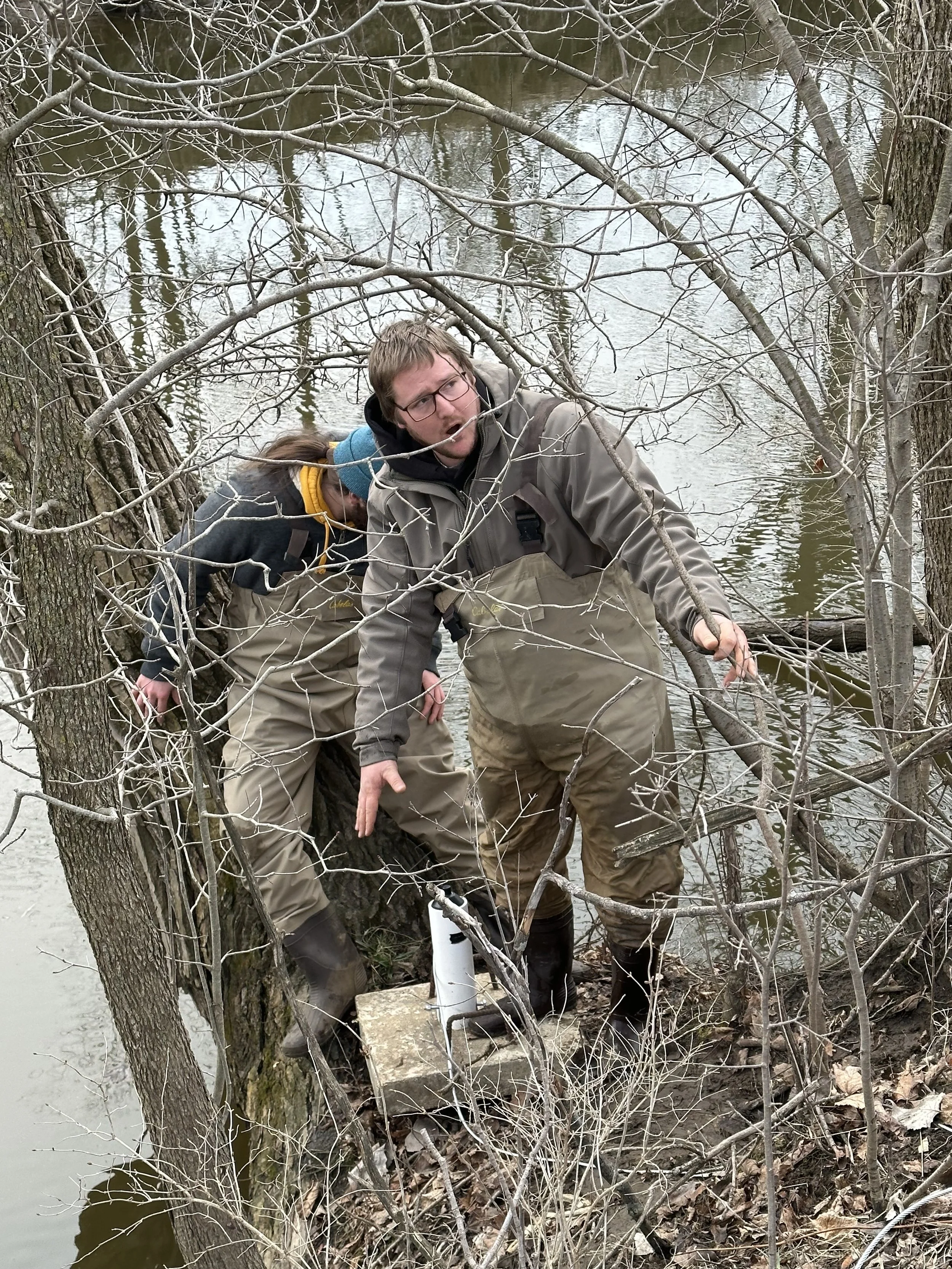 Bryan Miesen demonstrating fisheries research techniques to university students during research.