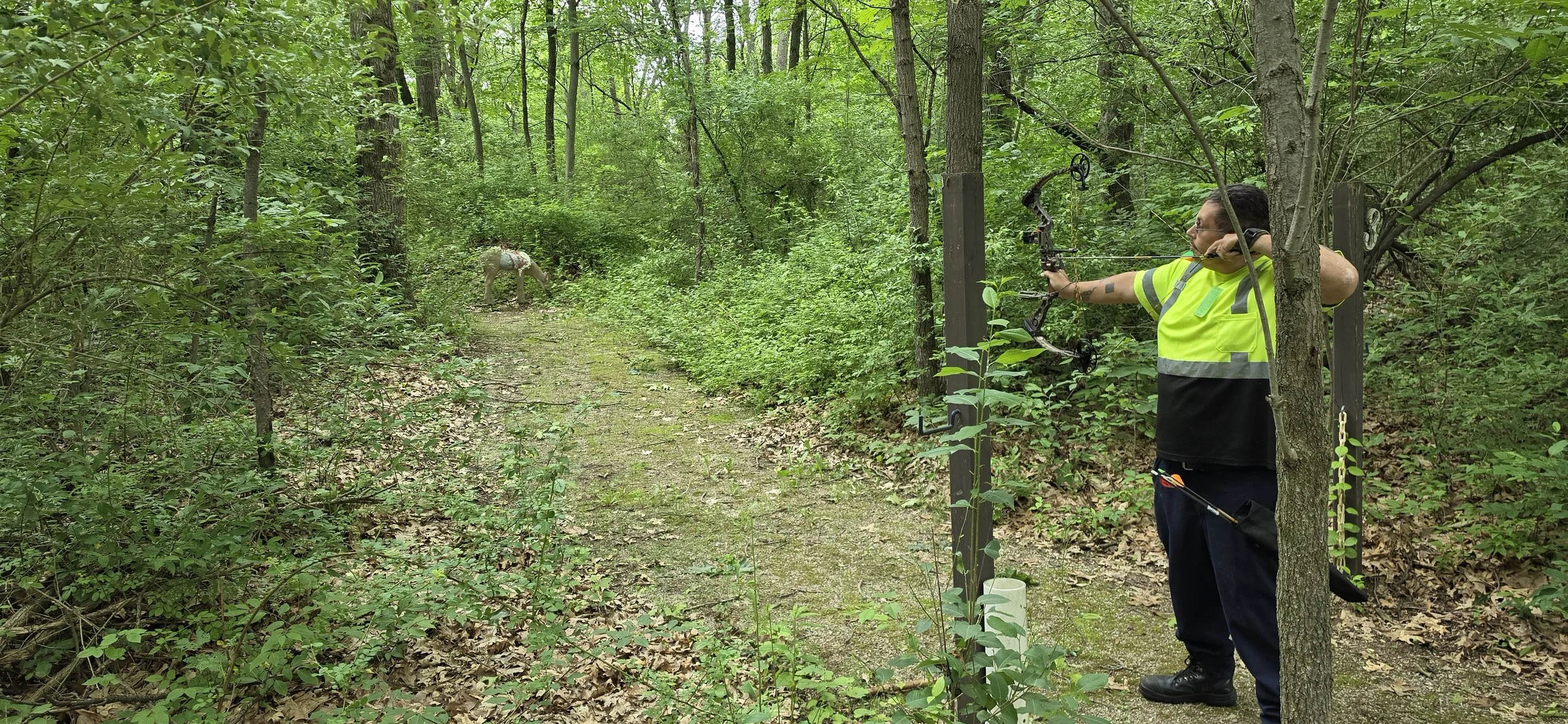Hunter practicing with a compound bow before a guided public land hunt in Michigan.