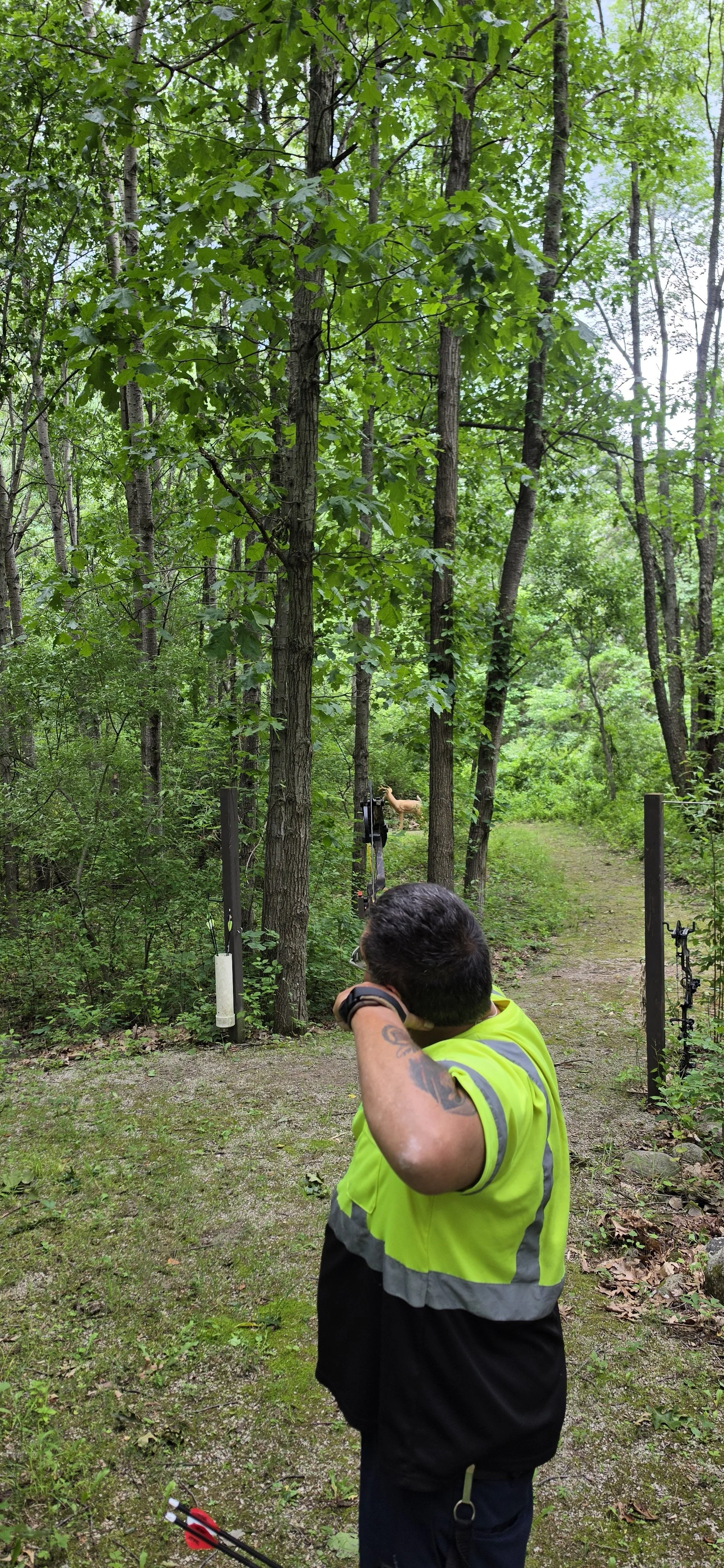 Hunter practicing with a compound bow during guided archery instruction in Michigan.