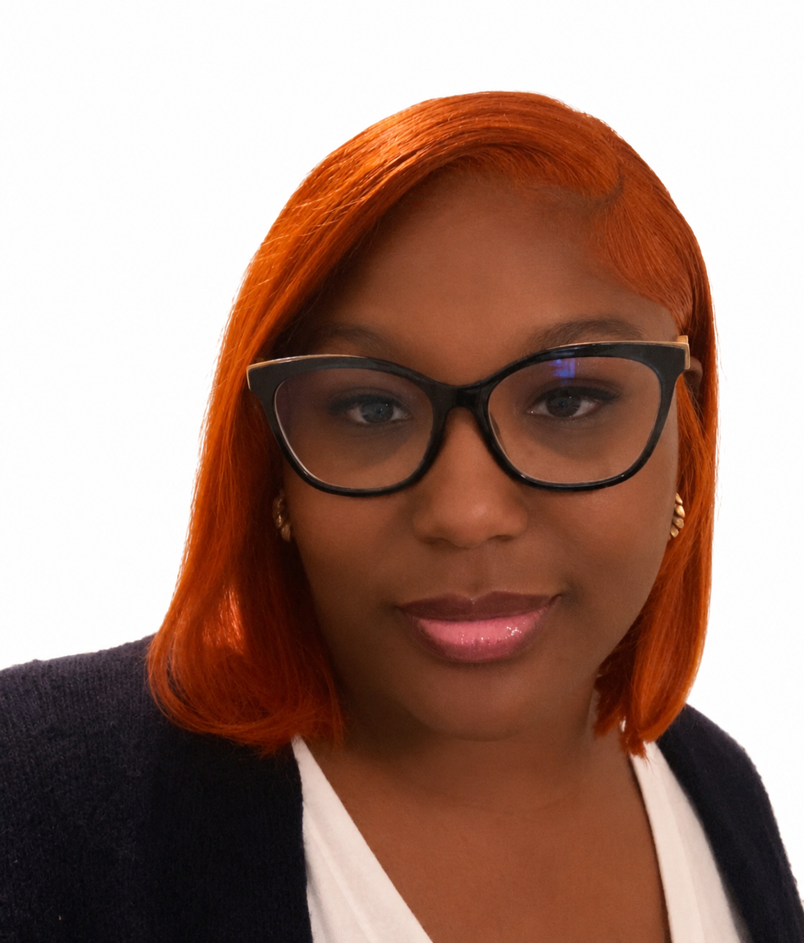 A woman with orange-red hair wearing glasses, a black blazer, and a white top, looking at the camera with a slight smile.