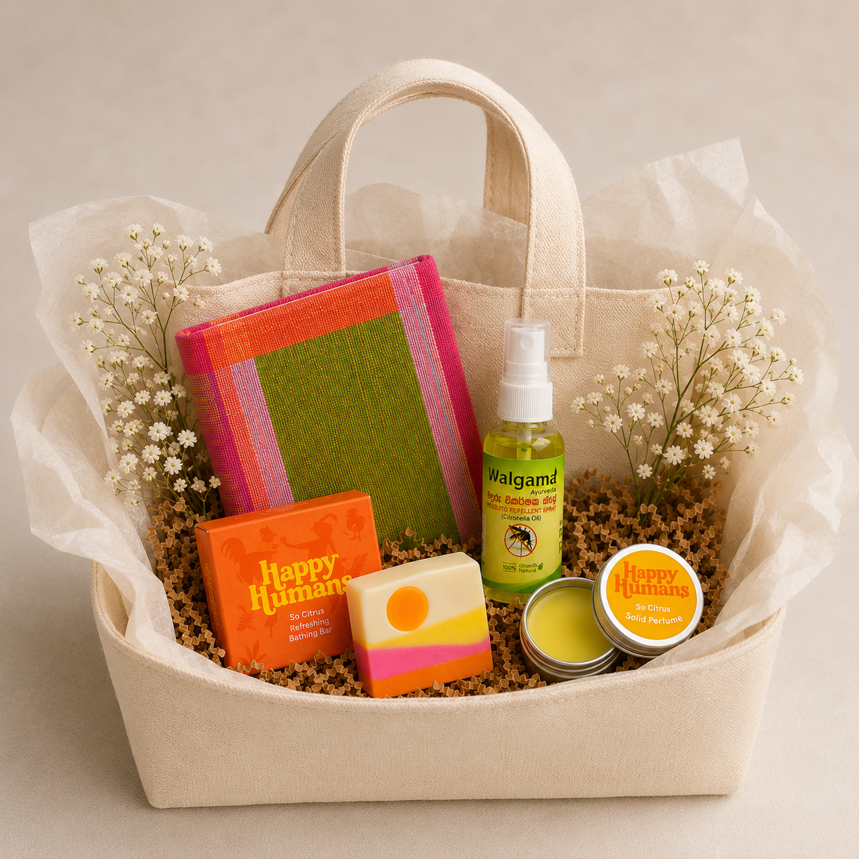 Gift basket with a beige cloth bag containing flowers and various health and wellness products, including soap, lotion, spray, and scented candle.