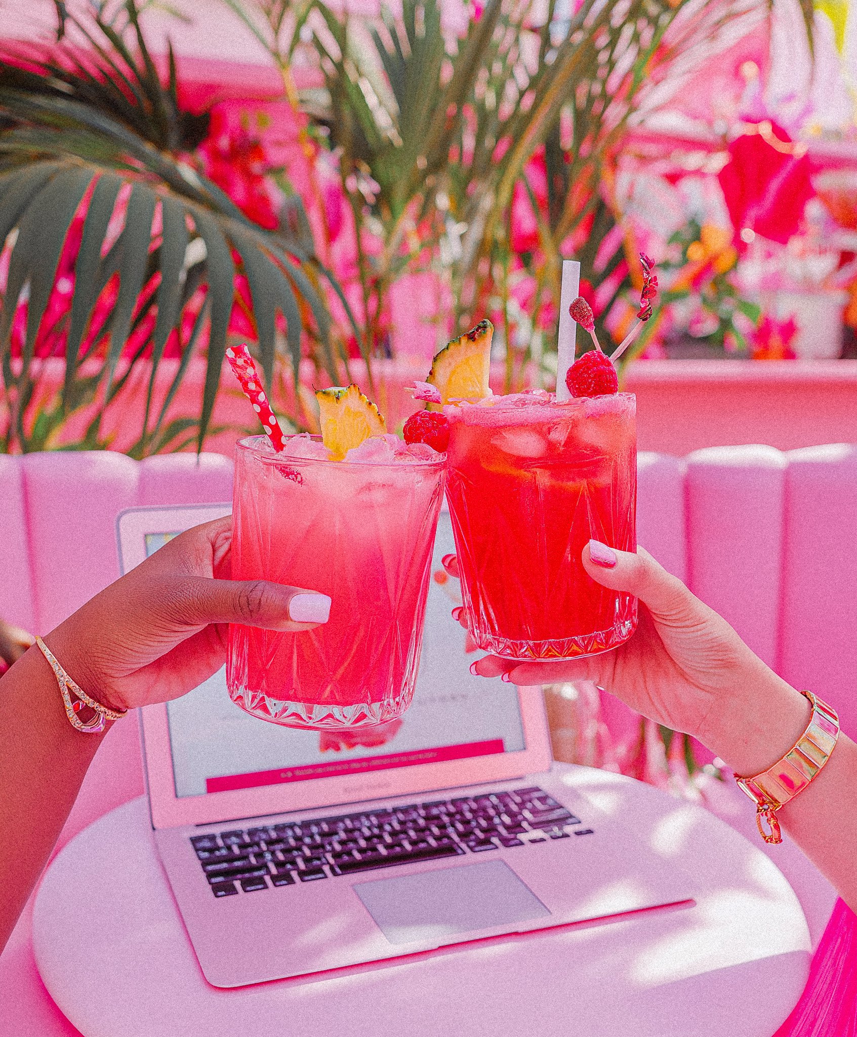 Two women clinking their drinks together to symbolize fun in collaborative partnerships.