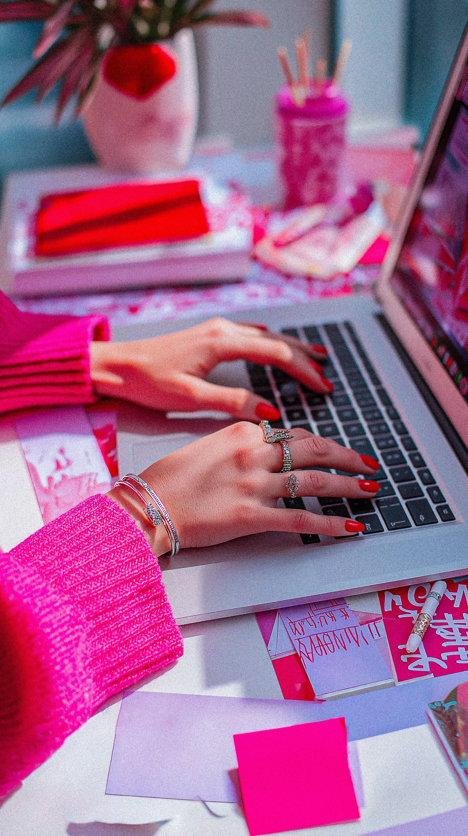 A woman types on her laptop writing a blog about sponsored content.