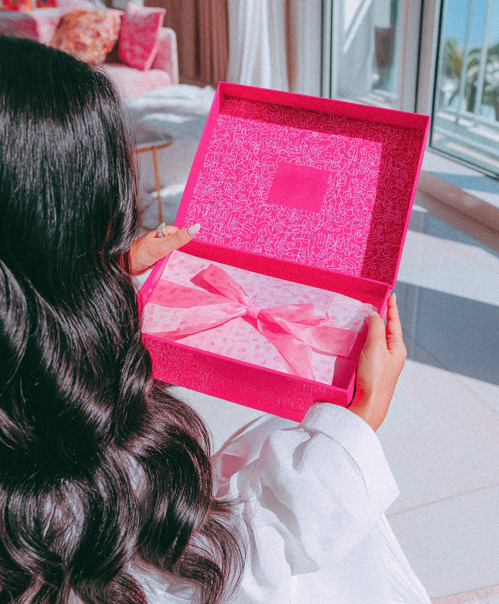 A woman unboxes a gifted collab campaign product for the camera as a content creator.