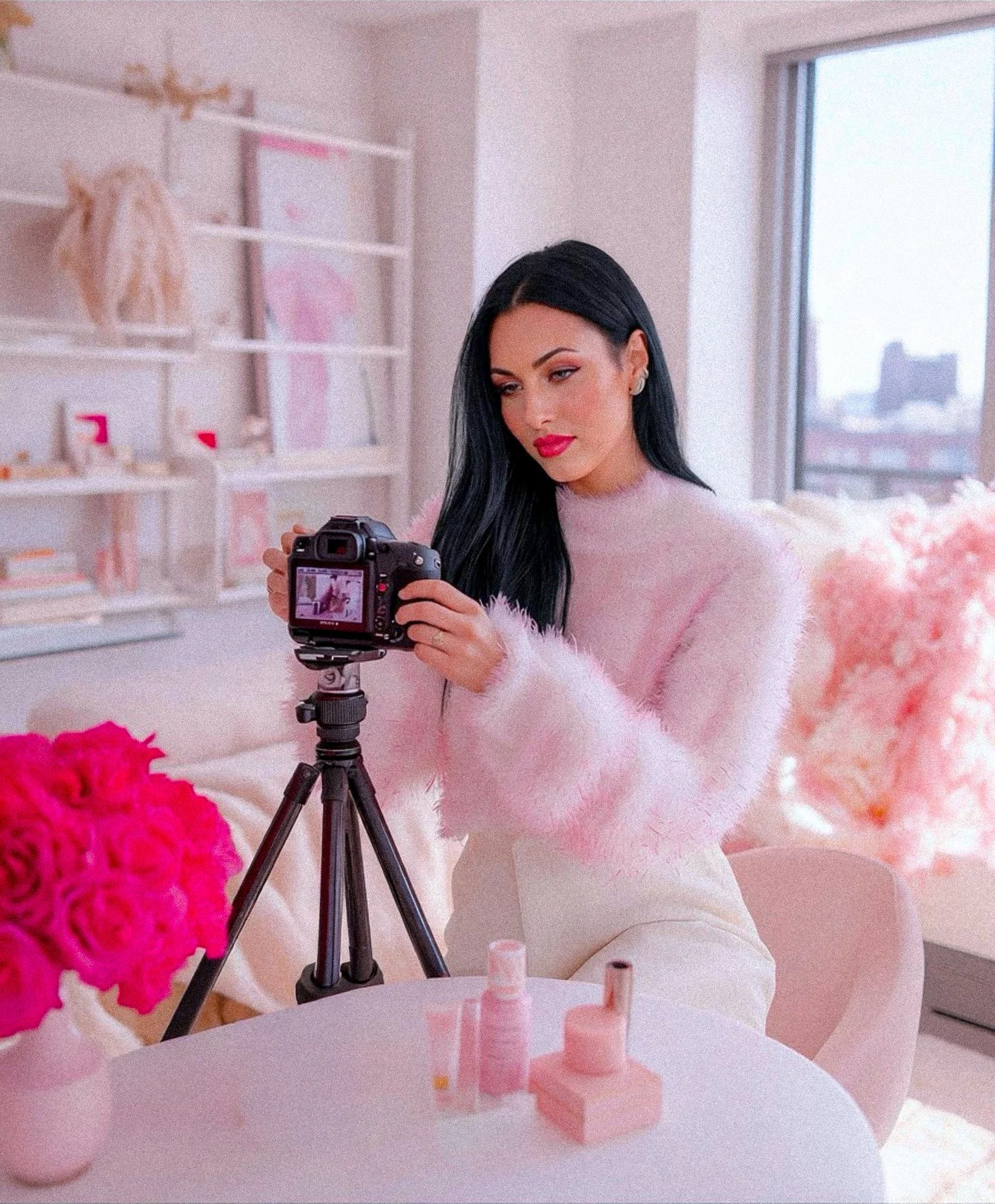 Brittany checks out her camera to make sure everything is in order to start recording her vlog.