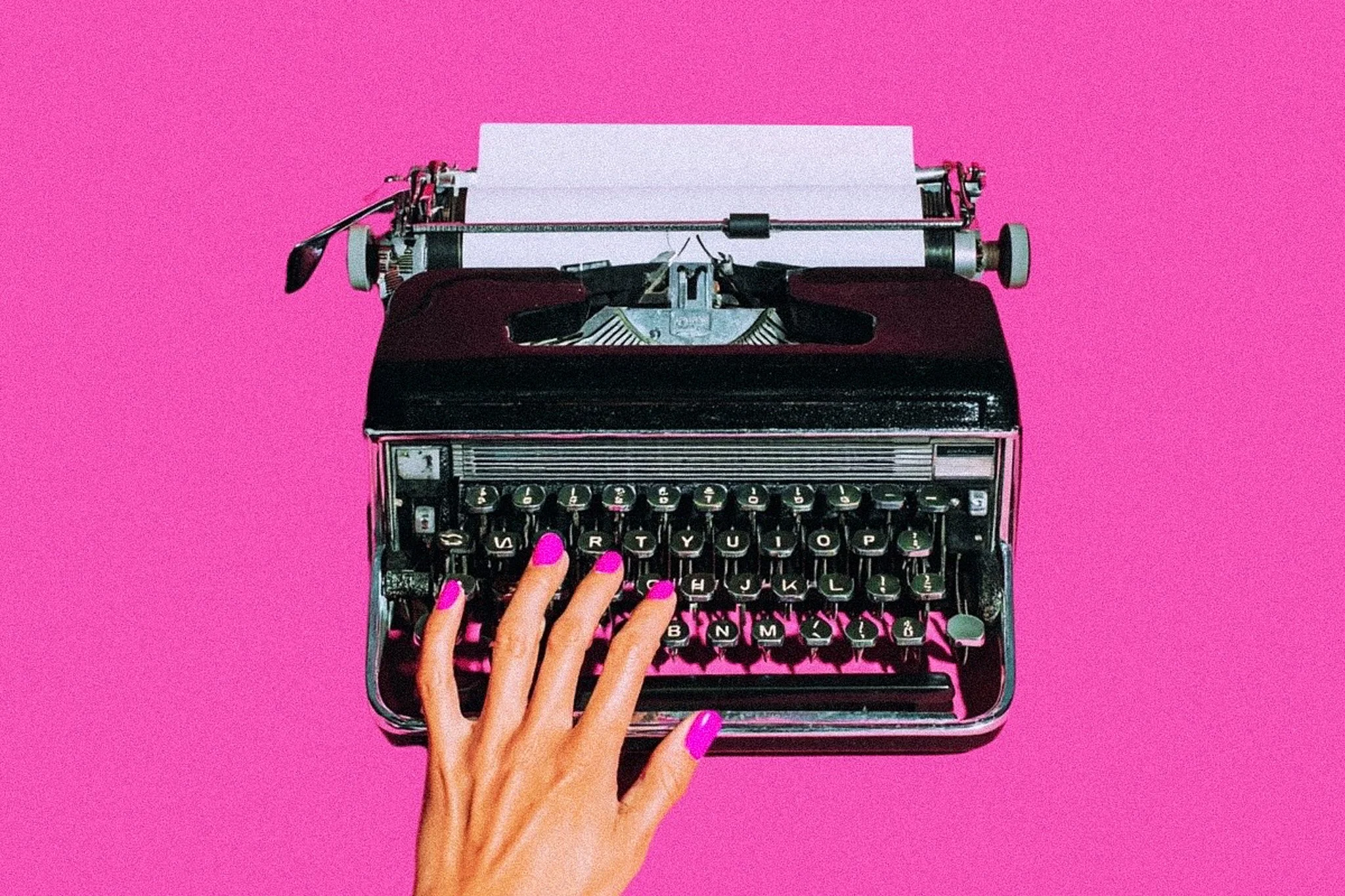 A black typewriter on a pink background to symbolize blogging, content marketing blogs and tech blogs.