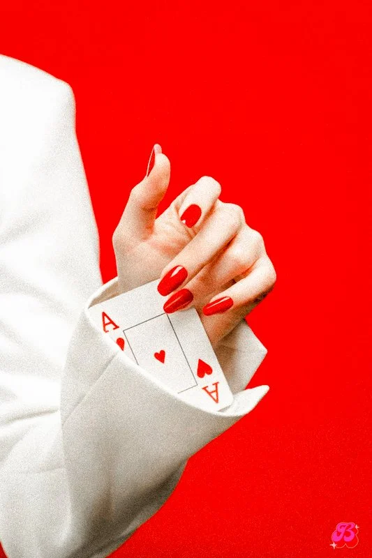A hand holding out the Ace of Hearts playing card, symbolizing creative marketing strategy and logical moves.