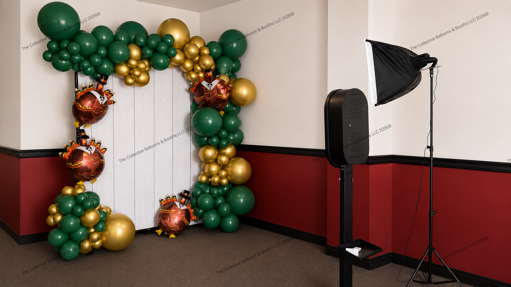 Decorative balloon arrangement with green, gold, and turkey-shaped balloons in a corner of a room, next to a photography lighting kit.