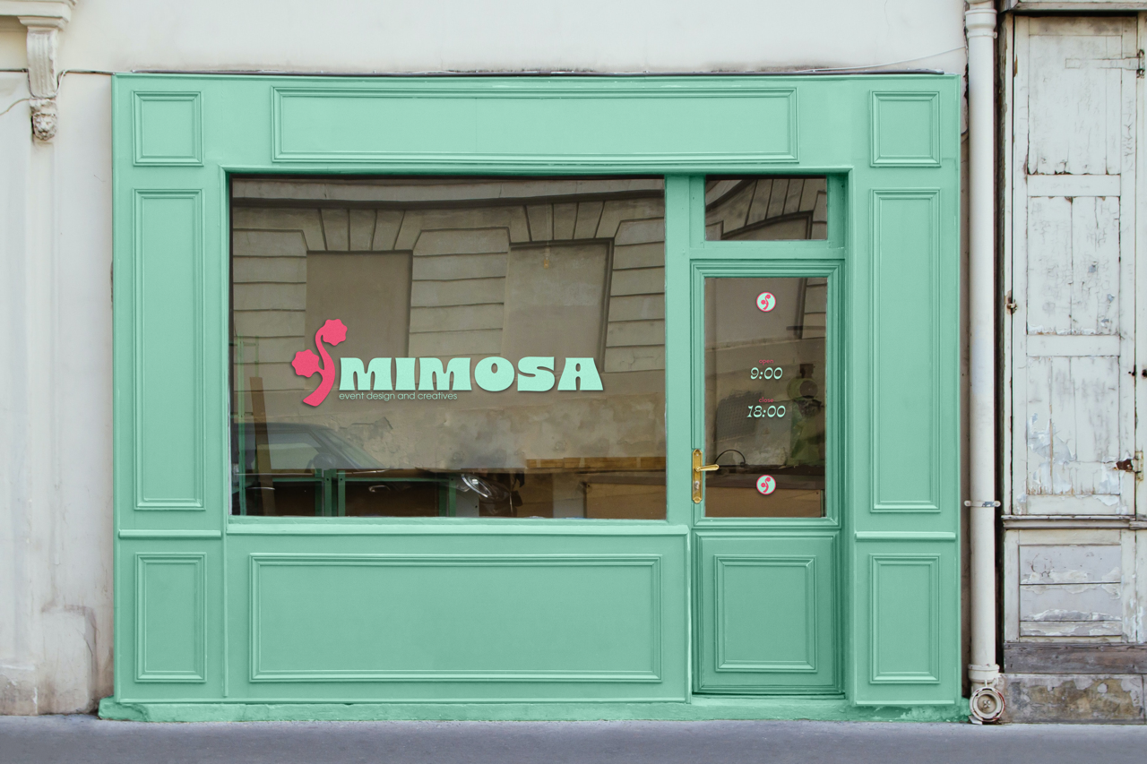 Green storefront with large window and door, displaying the name 'MIMOSA' with a pink seahorse logo, operating hours from 9:00 to 18:00.