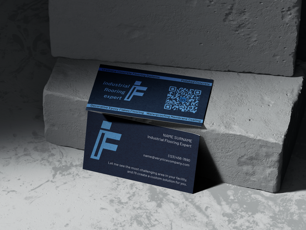 Business card for an industrial flooring expert placed on a concrete block, with a QR code and contact details visible.
