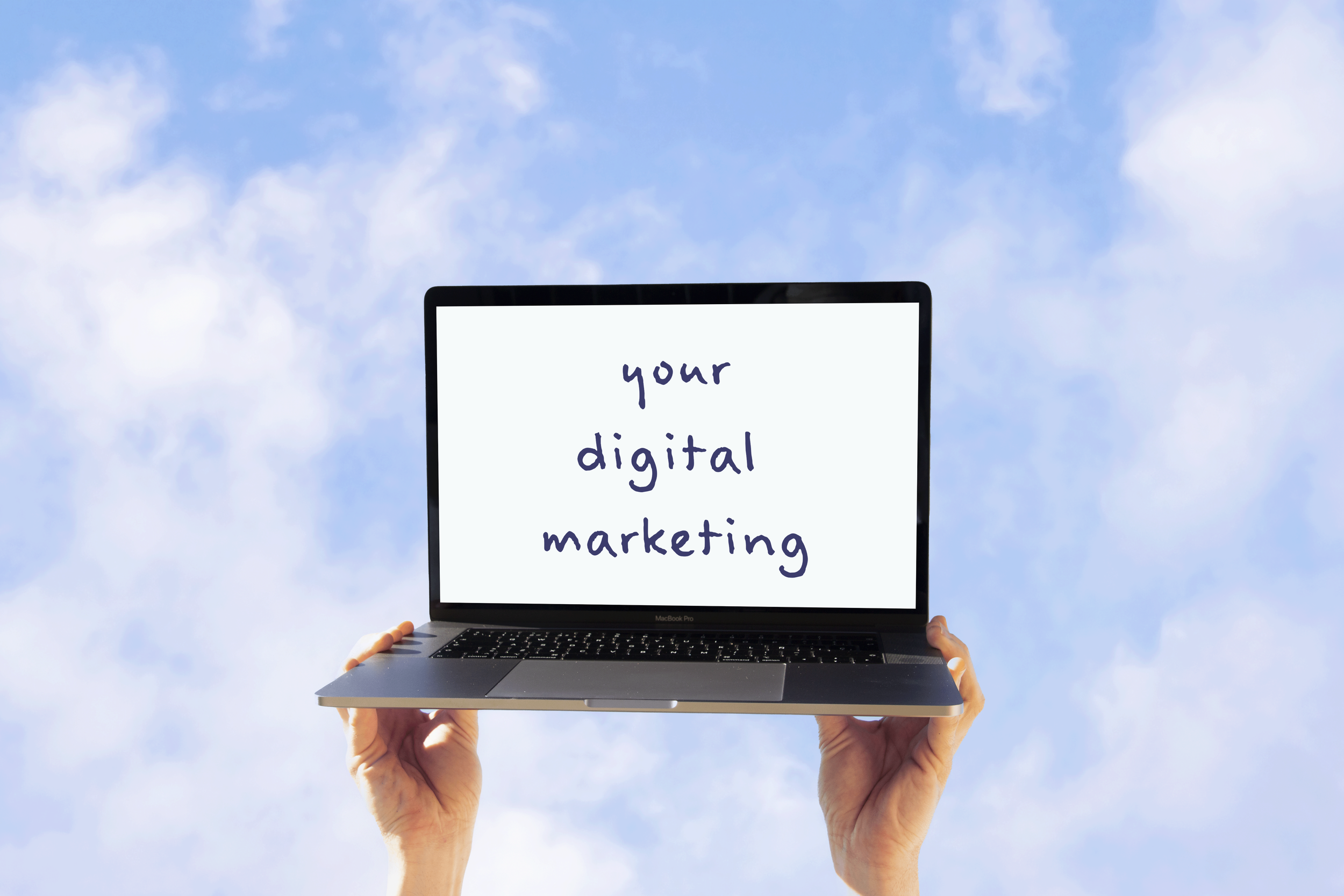 Person holding a laptop in the sky displaying the text "your digital marketing" on the screen.