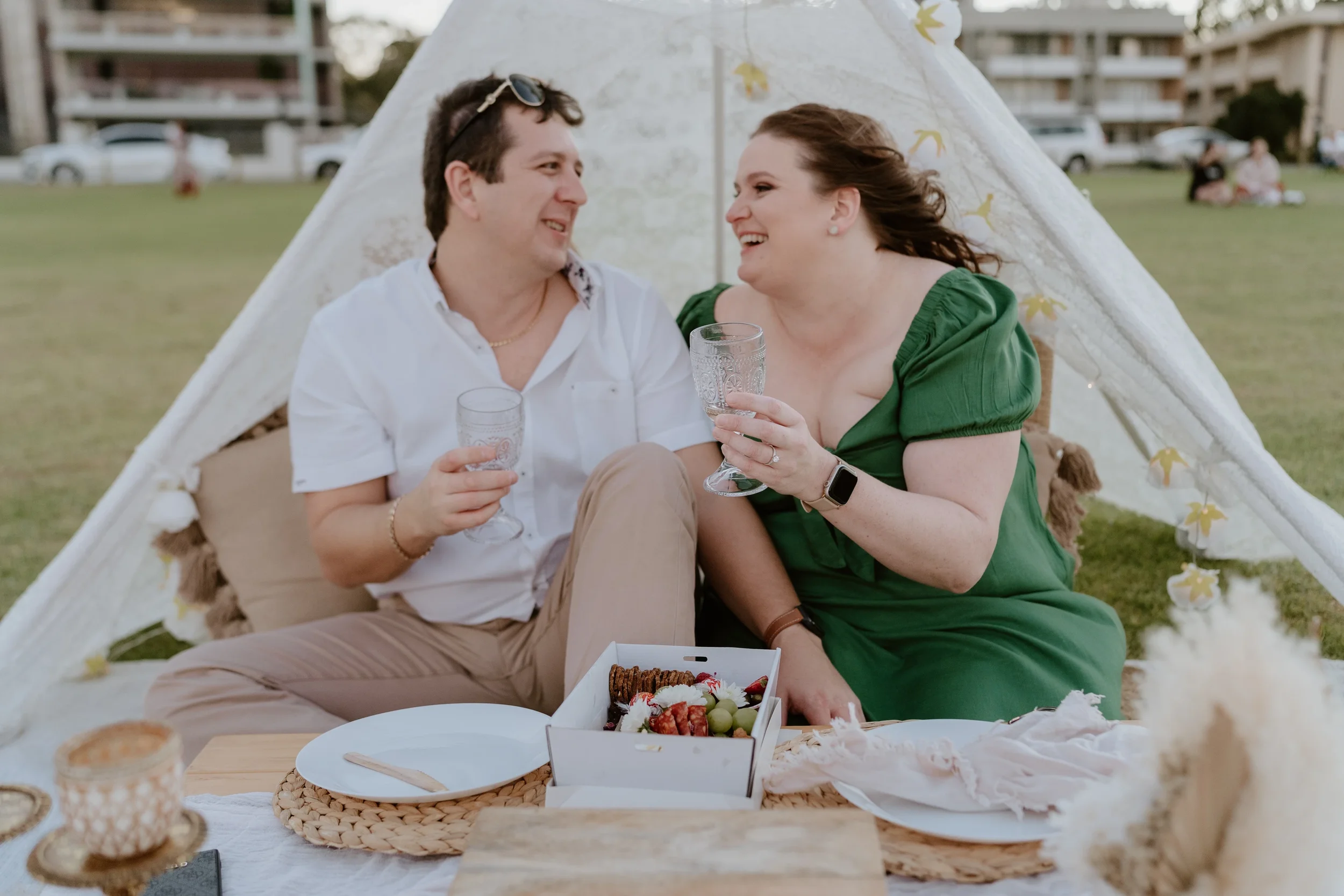 Clinton and Pauline enjoy their twilight picnic on the South Perth foreshore as they celebrate their surprise engagement