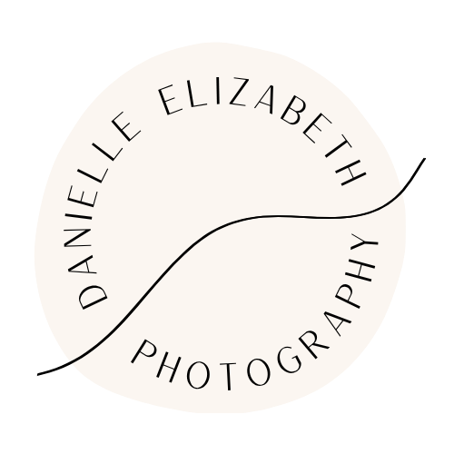 Logo of Danielle Elizabeth Photography with a stylized circle and a diagonal line through the center.