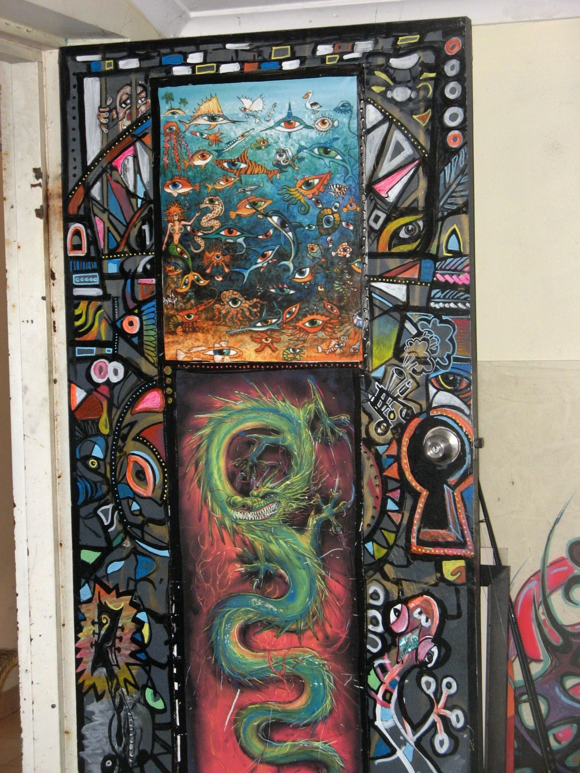 A vibrant, abstract artwork featuring colorful eyes, a blue underwater scene with fish and octopuses, and a green dragon on a red and black background, with a black frame and various geometric patterns.