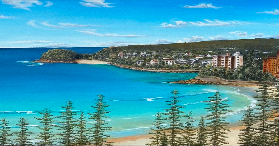 Manly to Shelly beach with turquoise water, sandy shoreline, pine trees in the foreground, residential buildings on the hills, and a partly cloudy sky.