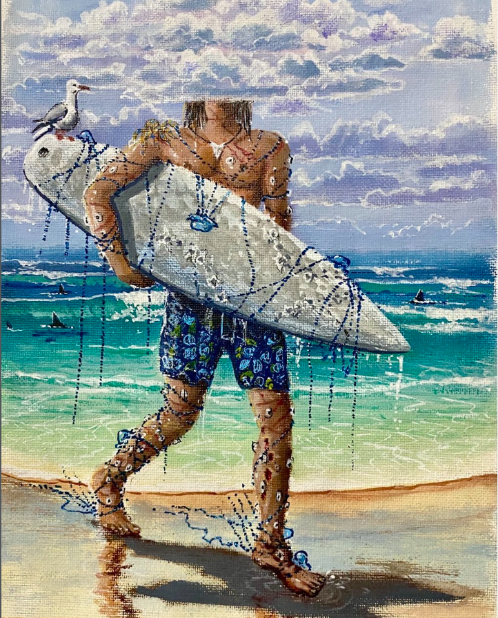 A person carrying a surfboard on a beach with ocean waves and sailboats in the background.