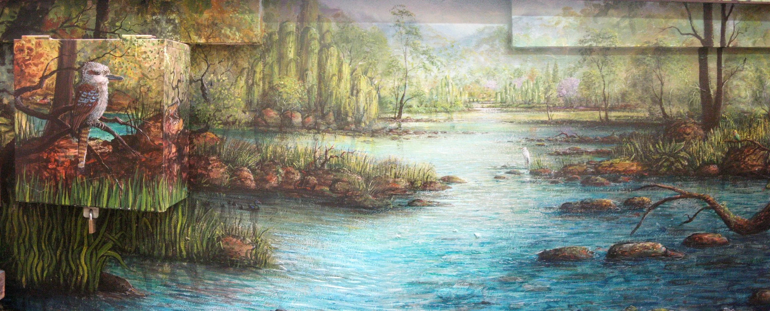 A scenic mural depicting a lush river landscape with trees, rocks, and a bird perched on a branch in the foreground, and a small white bird in the river in the distance.