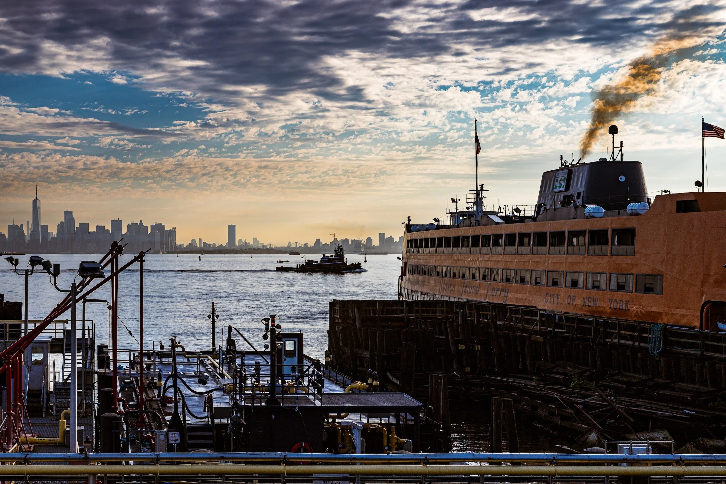 Close-up of the top portion of the Chrysler Building, an art deco skyscraper in New York City, showcasing its ornate spire and architectural details against a clear blue sky.