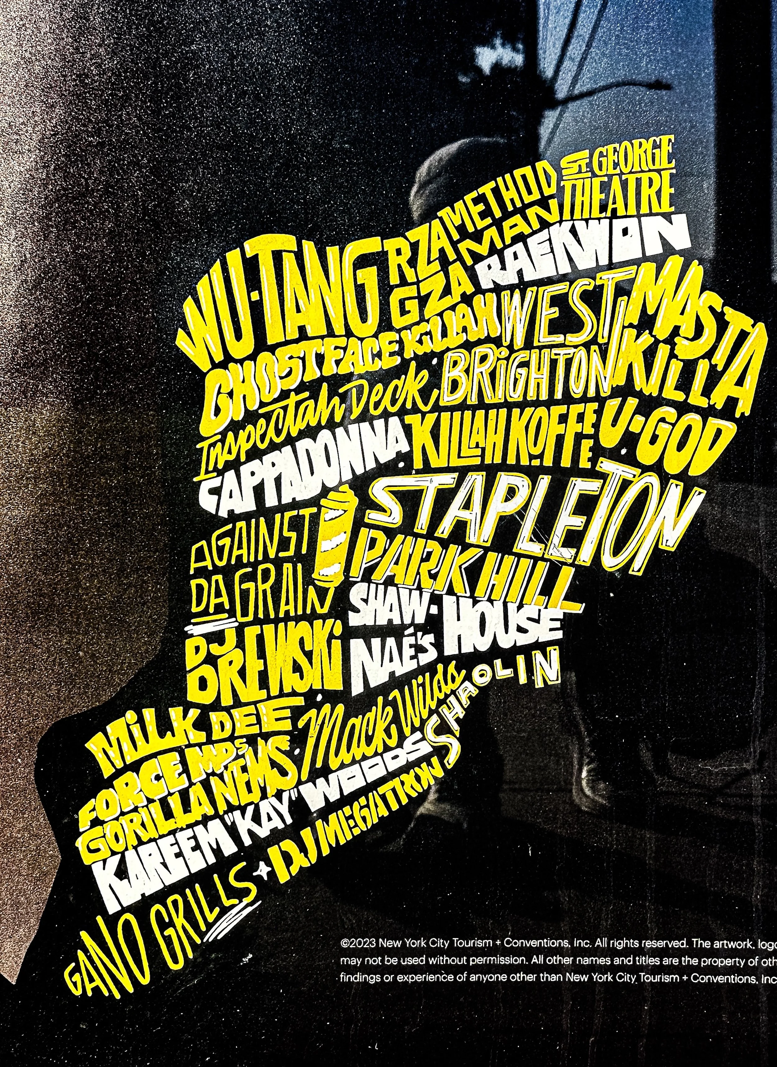 Artwork features a silhouette of a person's profile filled with names of various places and events in New York City, written in yellow and white text.
