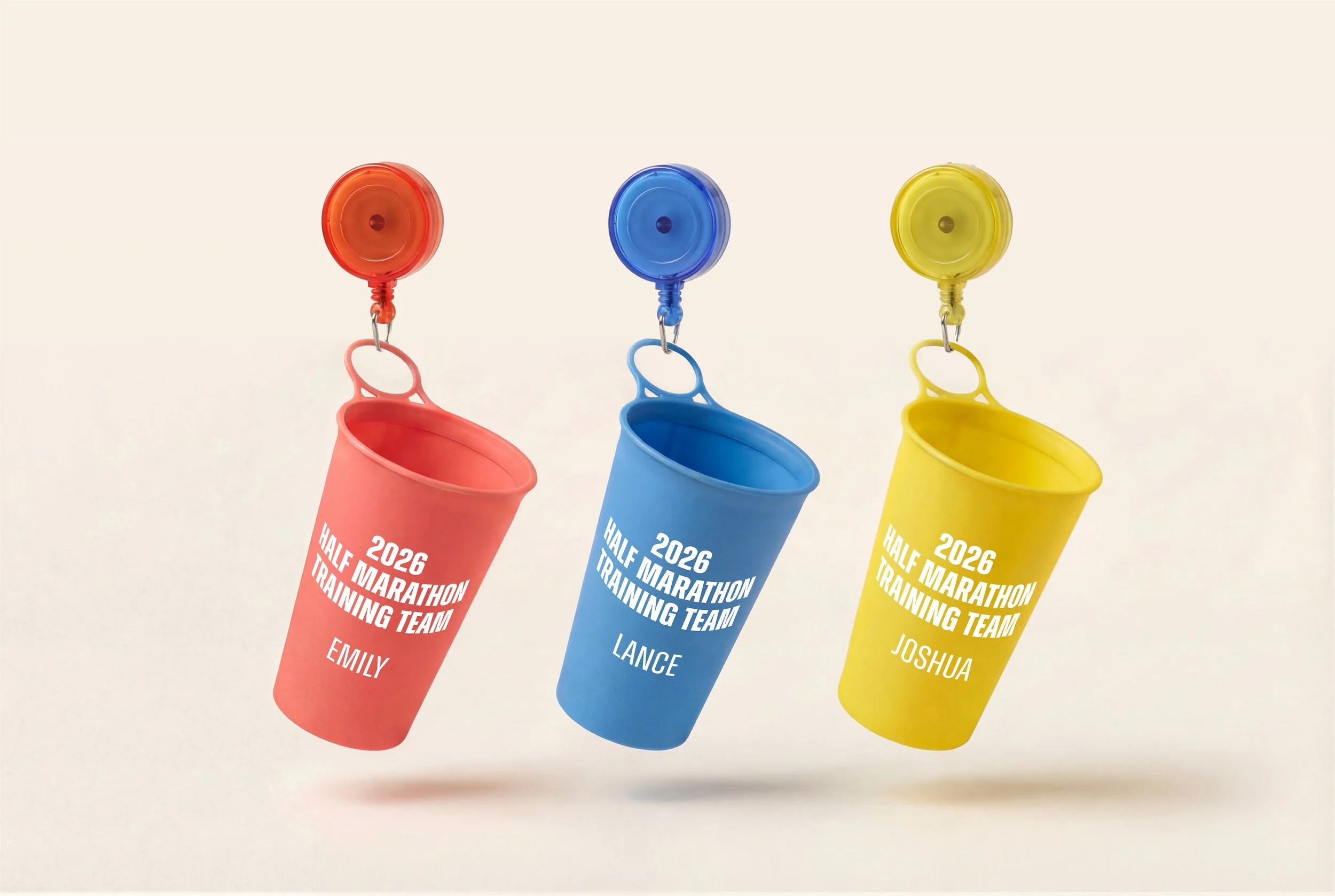 Colorful plastic cups with suction cups and clips, each with the text "2026 Half Marathon Training Team" and a name: Emily, Lance, and Joshua