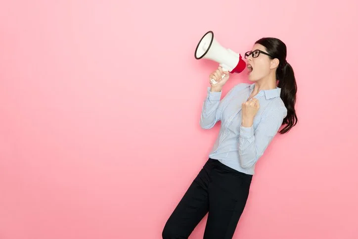 Woman with megaphone symbolising confident communication and managing upwards