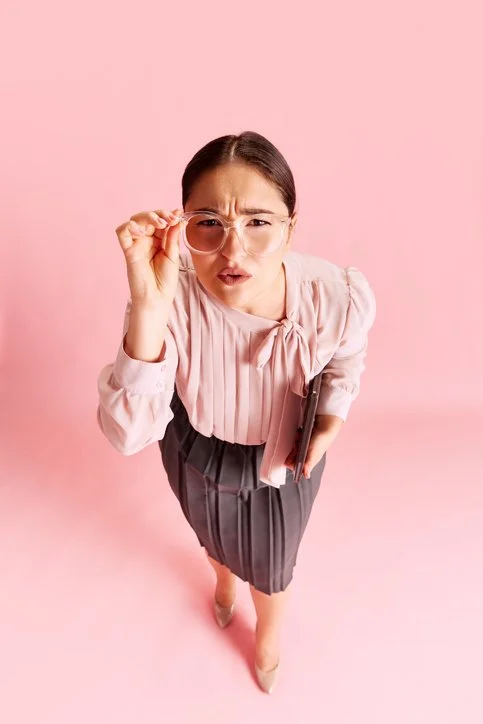 Questioning Lady peering over her glasses as if she's trying to make sure she is clear