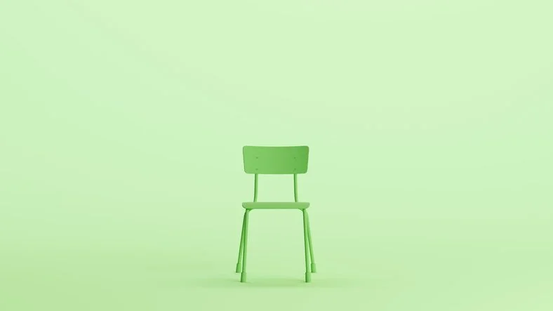 A single green chair against a pale green background representing limited spots on a training course.