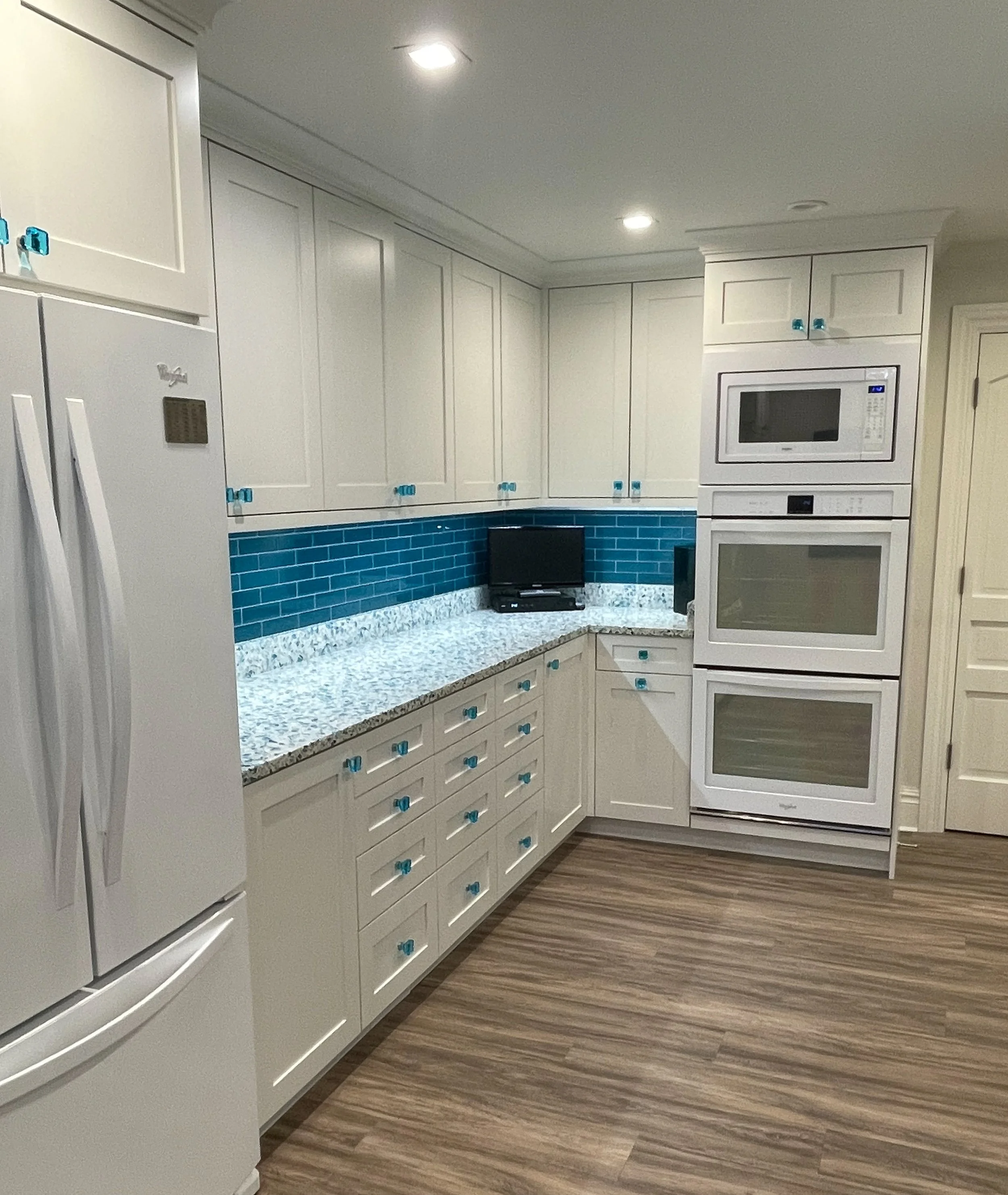 White kitchen with blue backsplash and hardware 