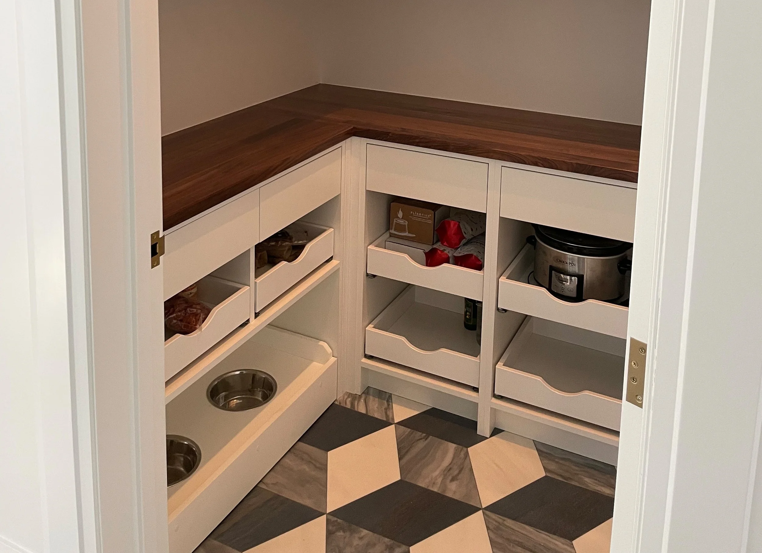 White pantry with wood top and custom dog bowls 