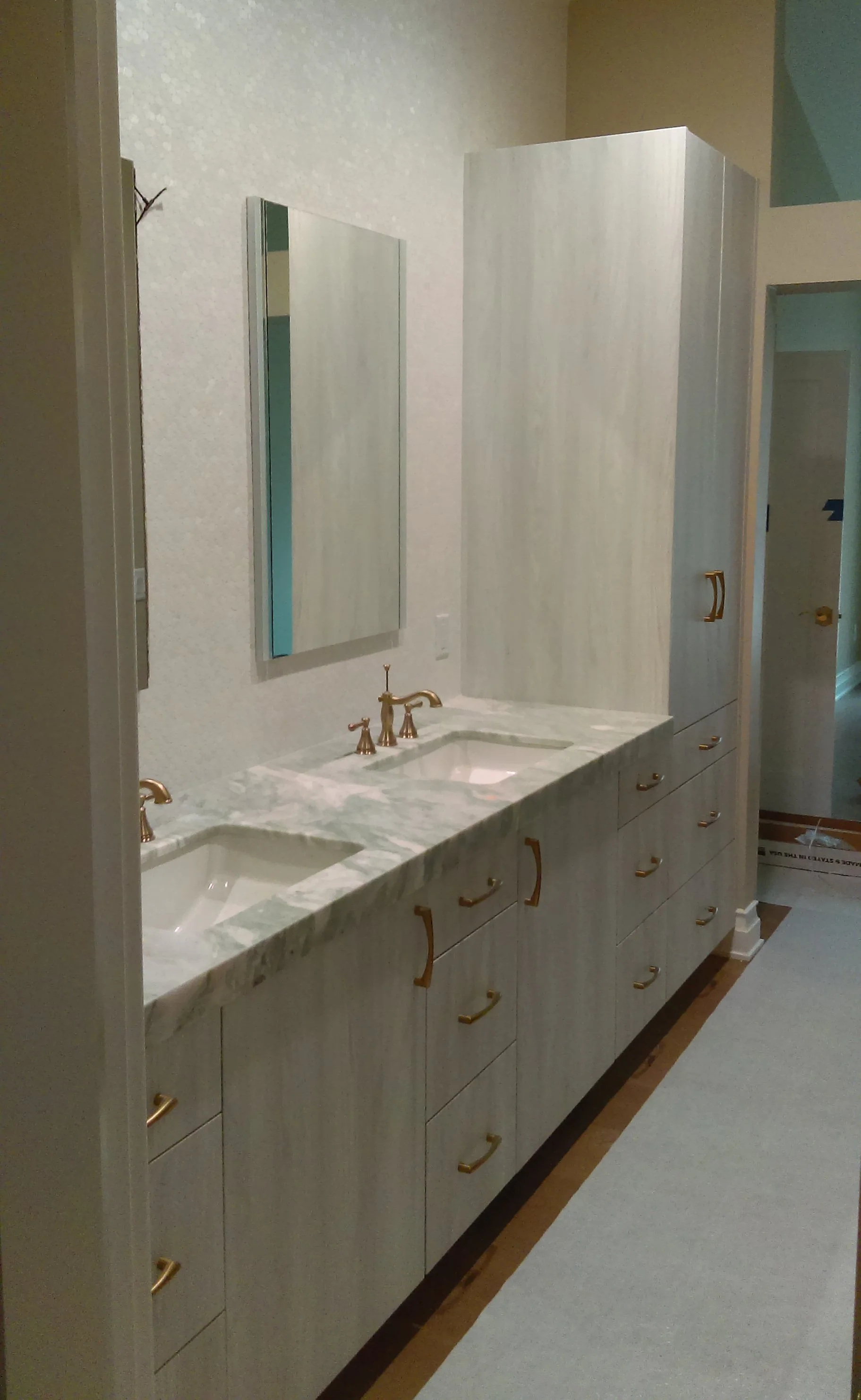 Custom vanity with linen cabinets on either side