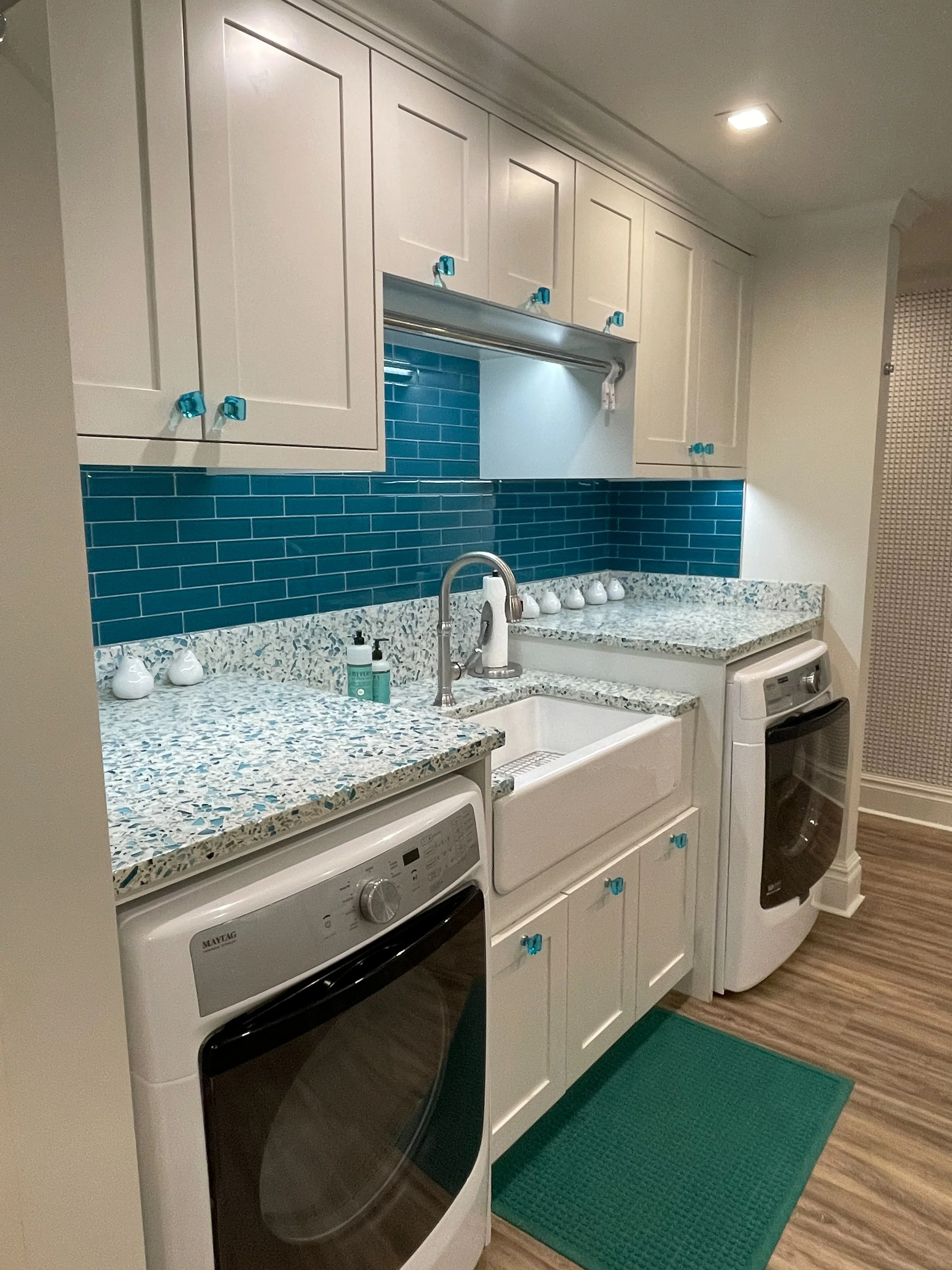 White kitchen with blue backsplash and hardware 