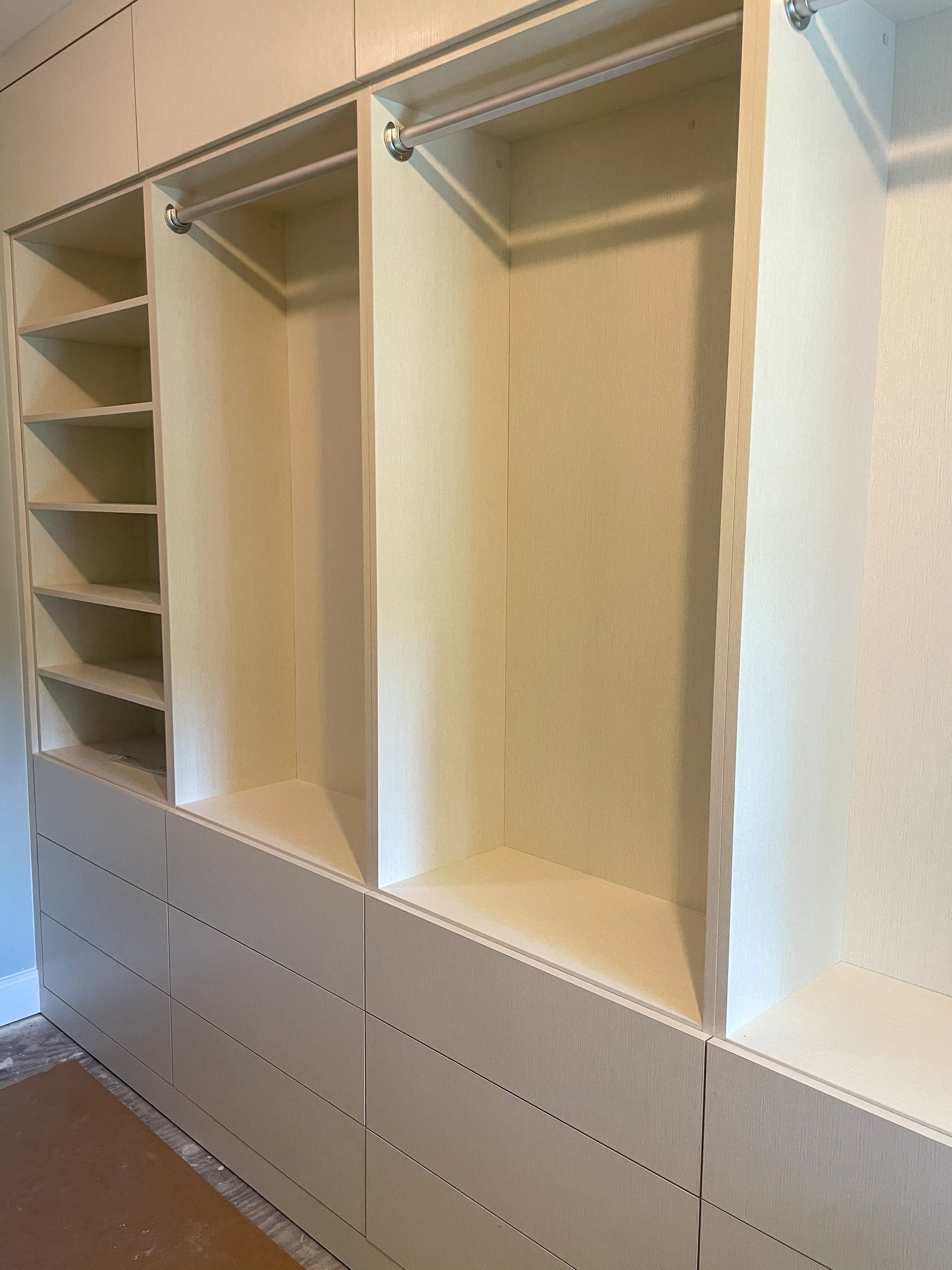 Modern white closet with slab drawers 