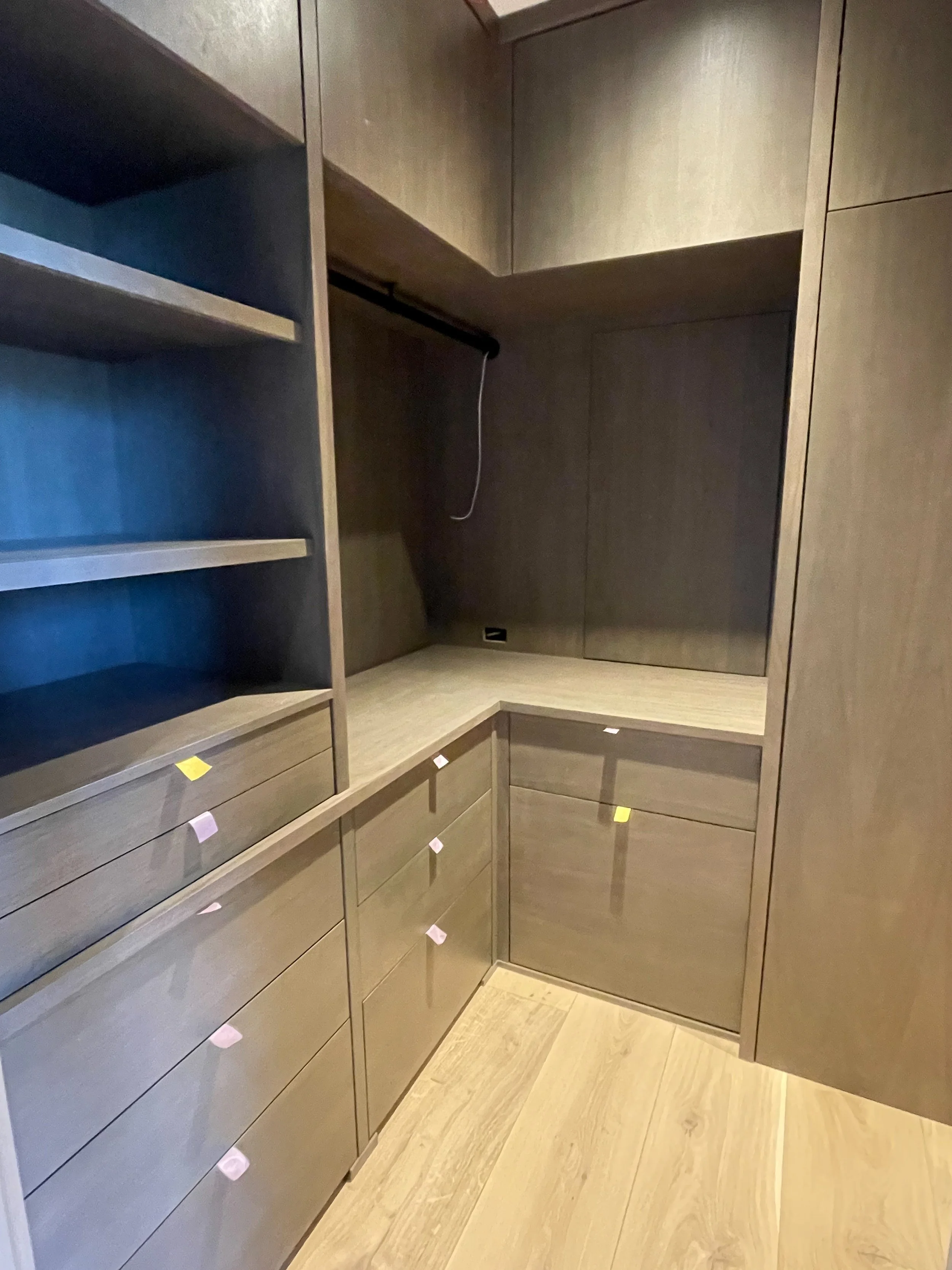 Modern dark wood closet with shelves, hanging, and drawers 
