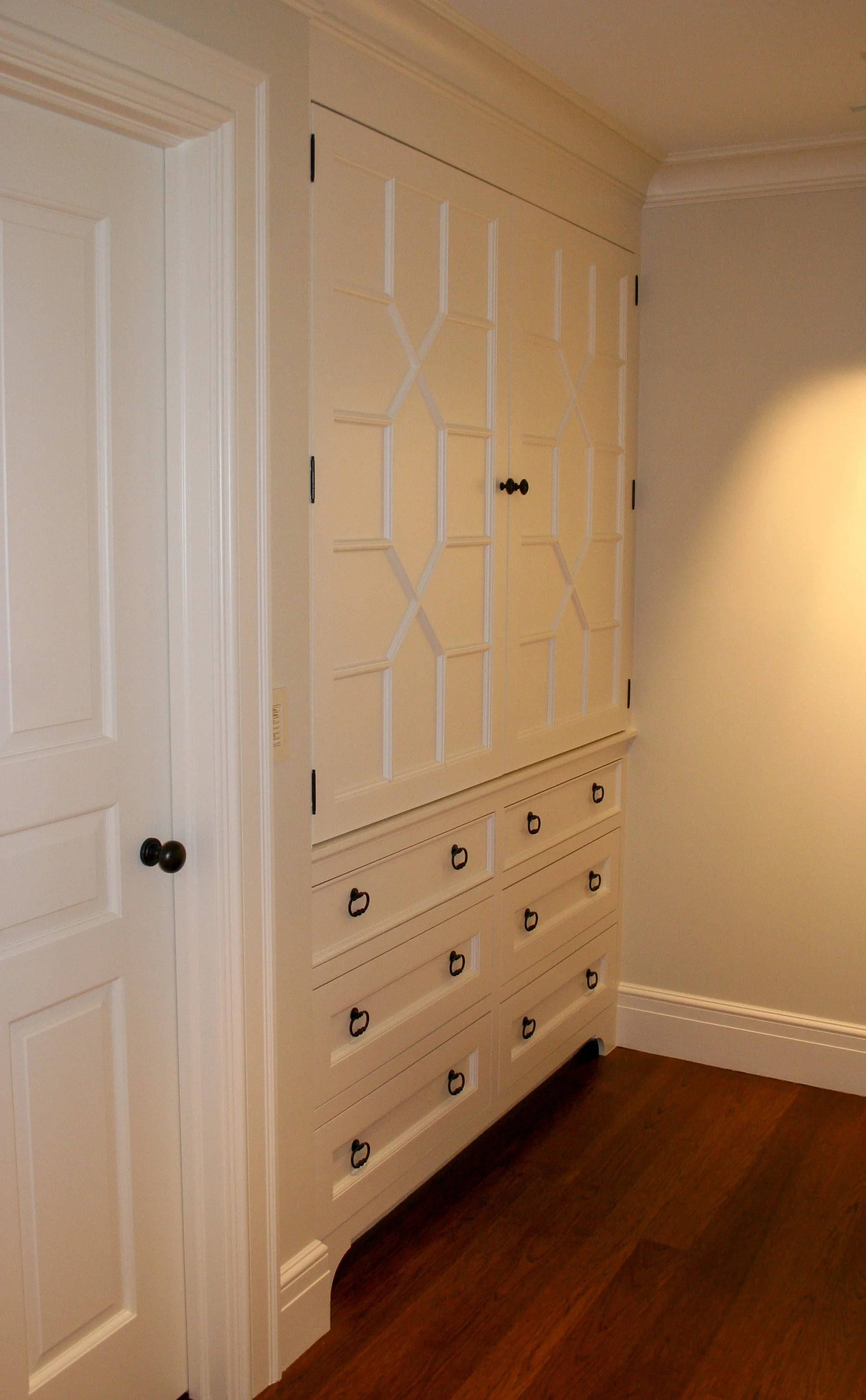 White built-in with custom applied molding on doors 