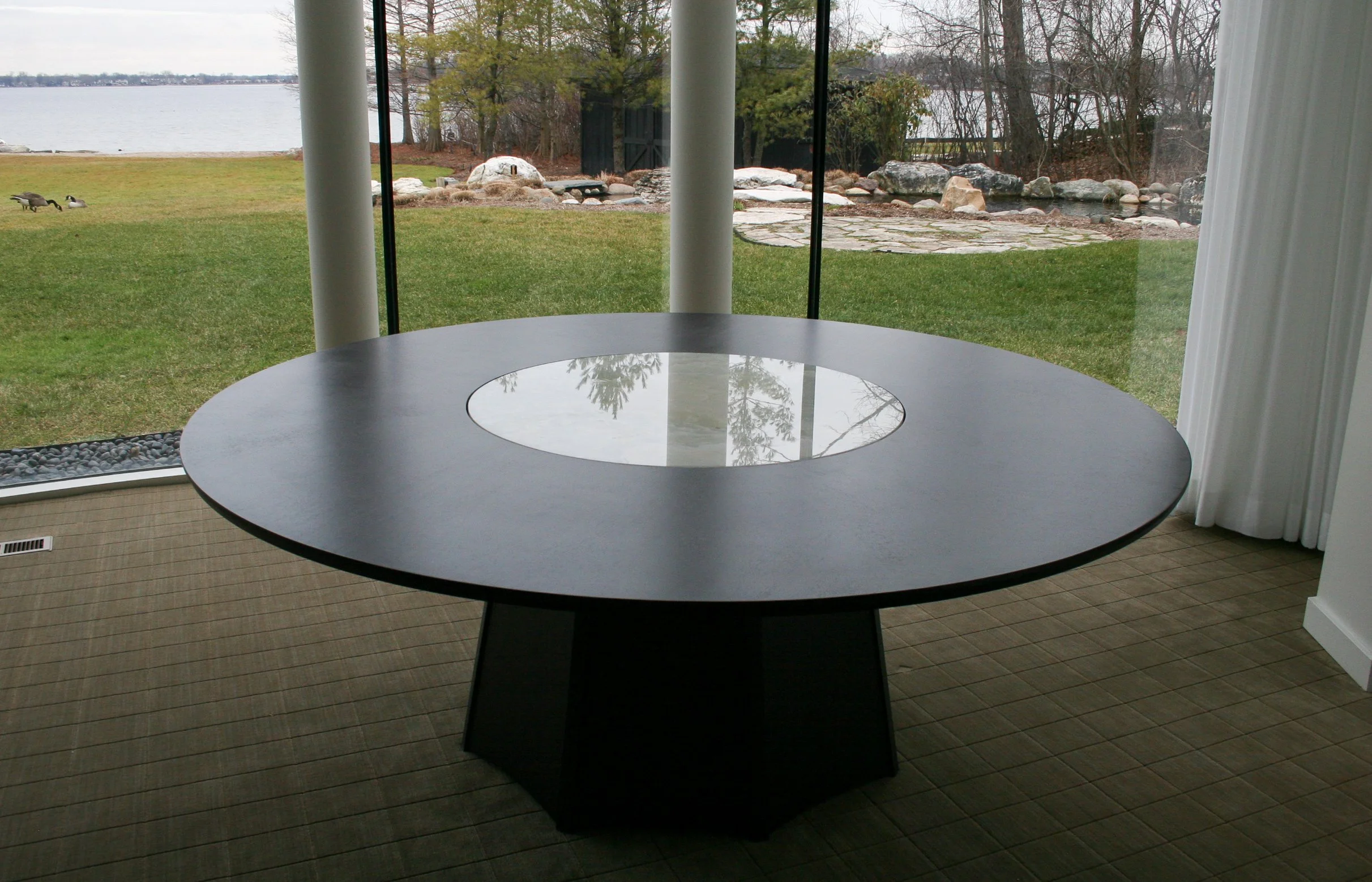 Custom pedestal dining table with fluted base and glass insert 