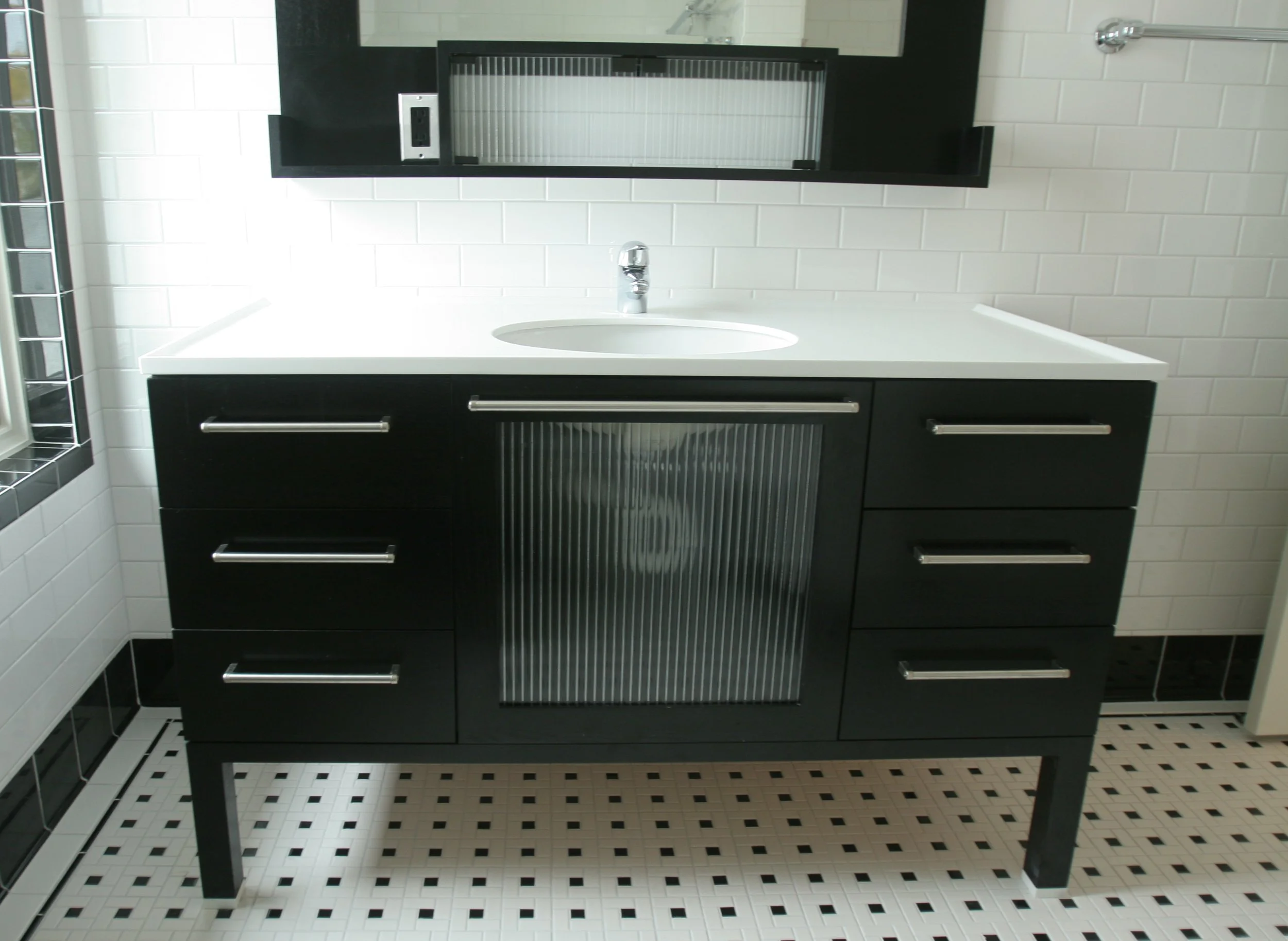 Black vanity with reeded glass center panel 
