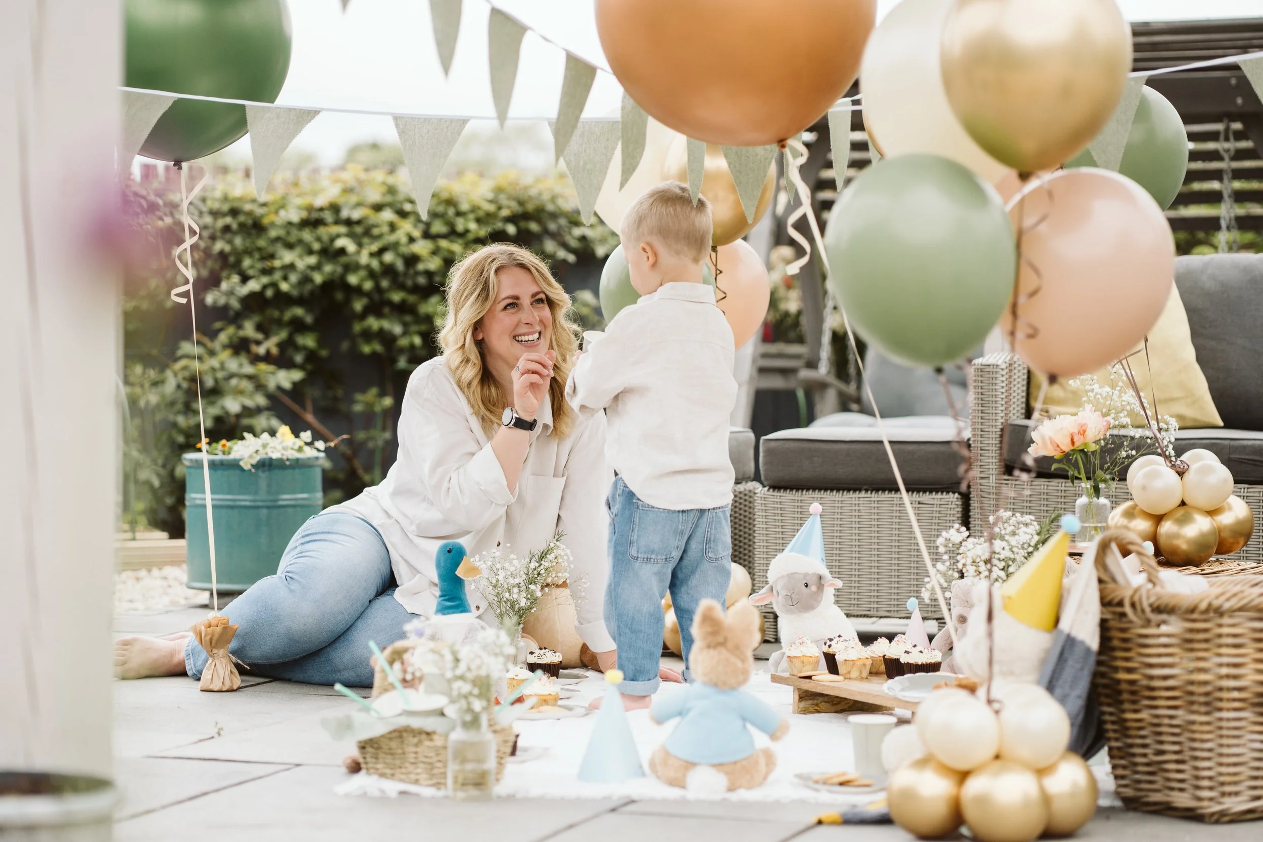 Child enjoying a colourful outdoor party table
