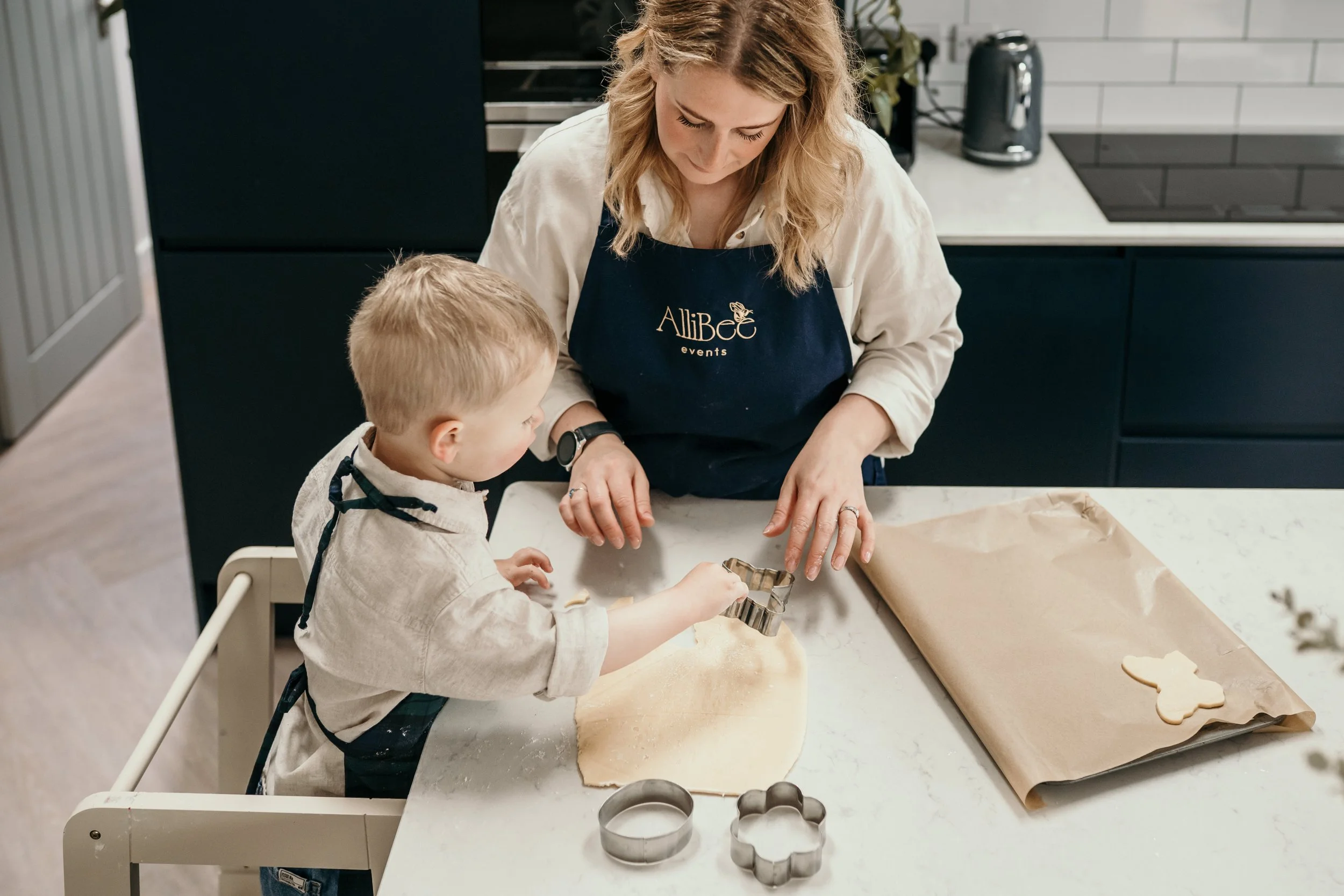 Mum and child making cookies together.