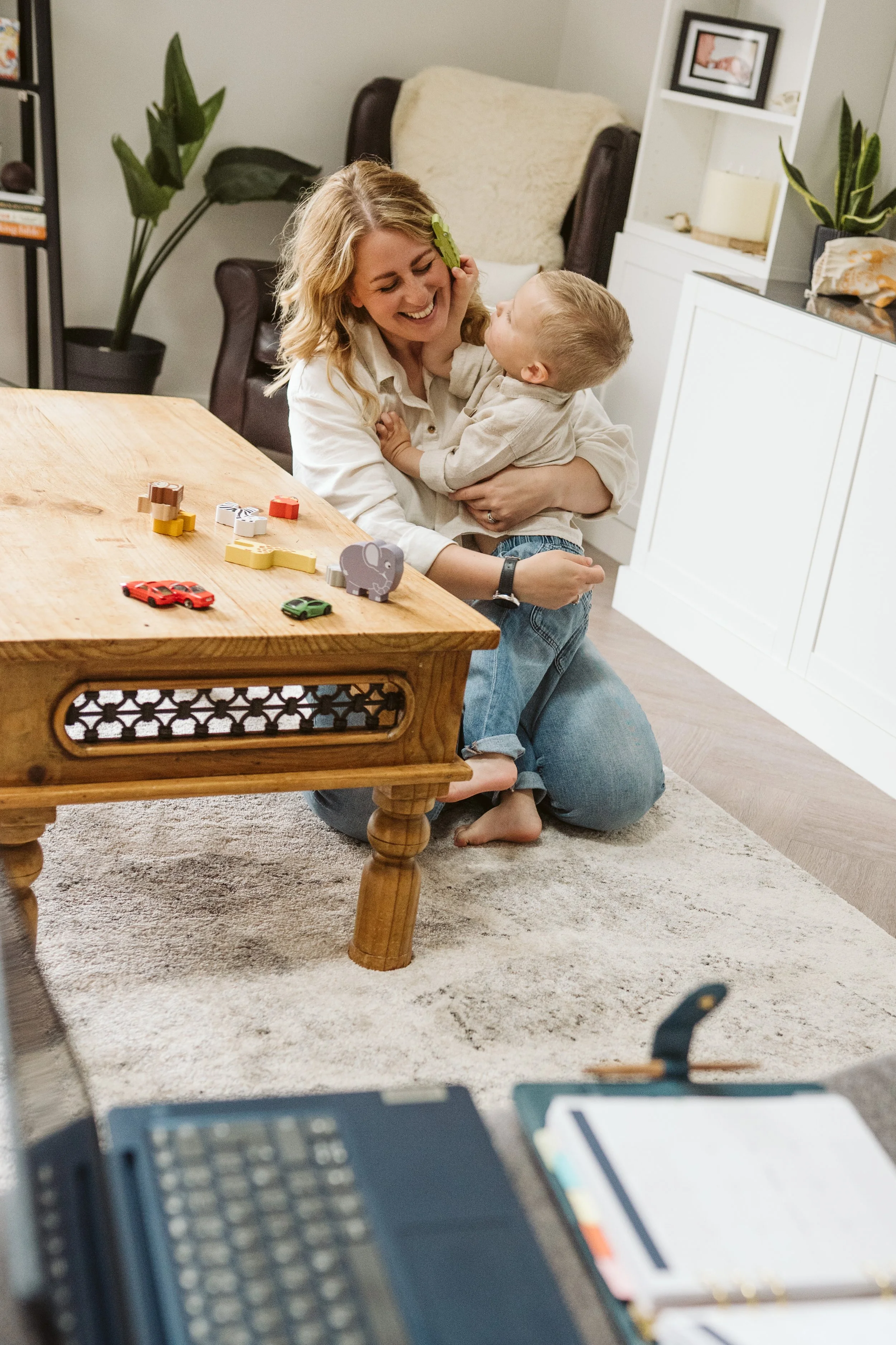 Mum and child cuddling and playing together at home