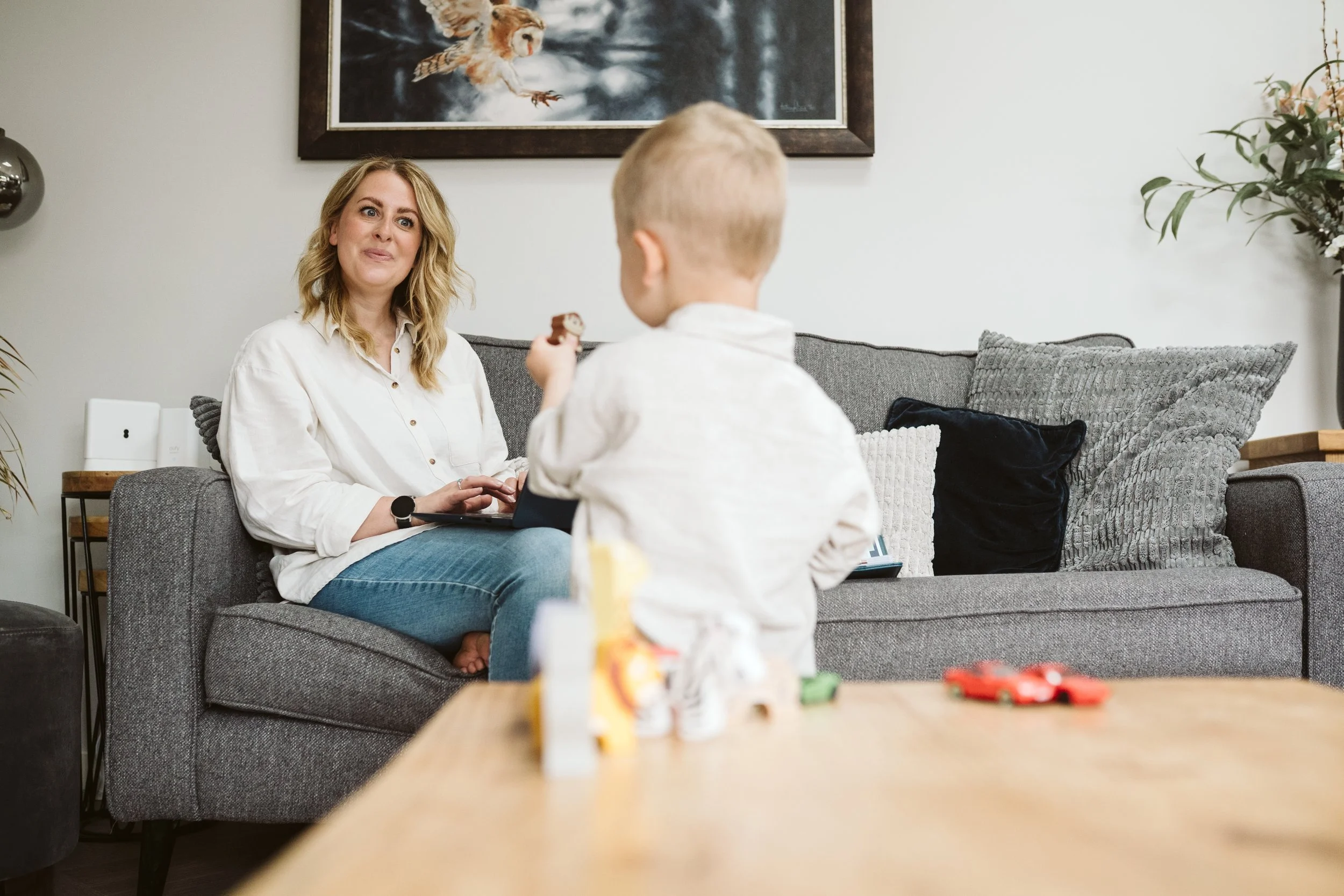 Child playing while mum watches nearby