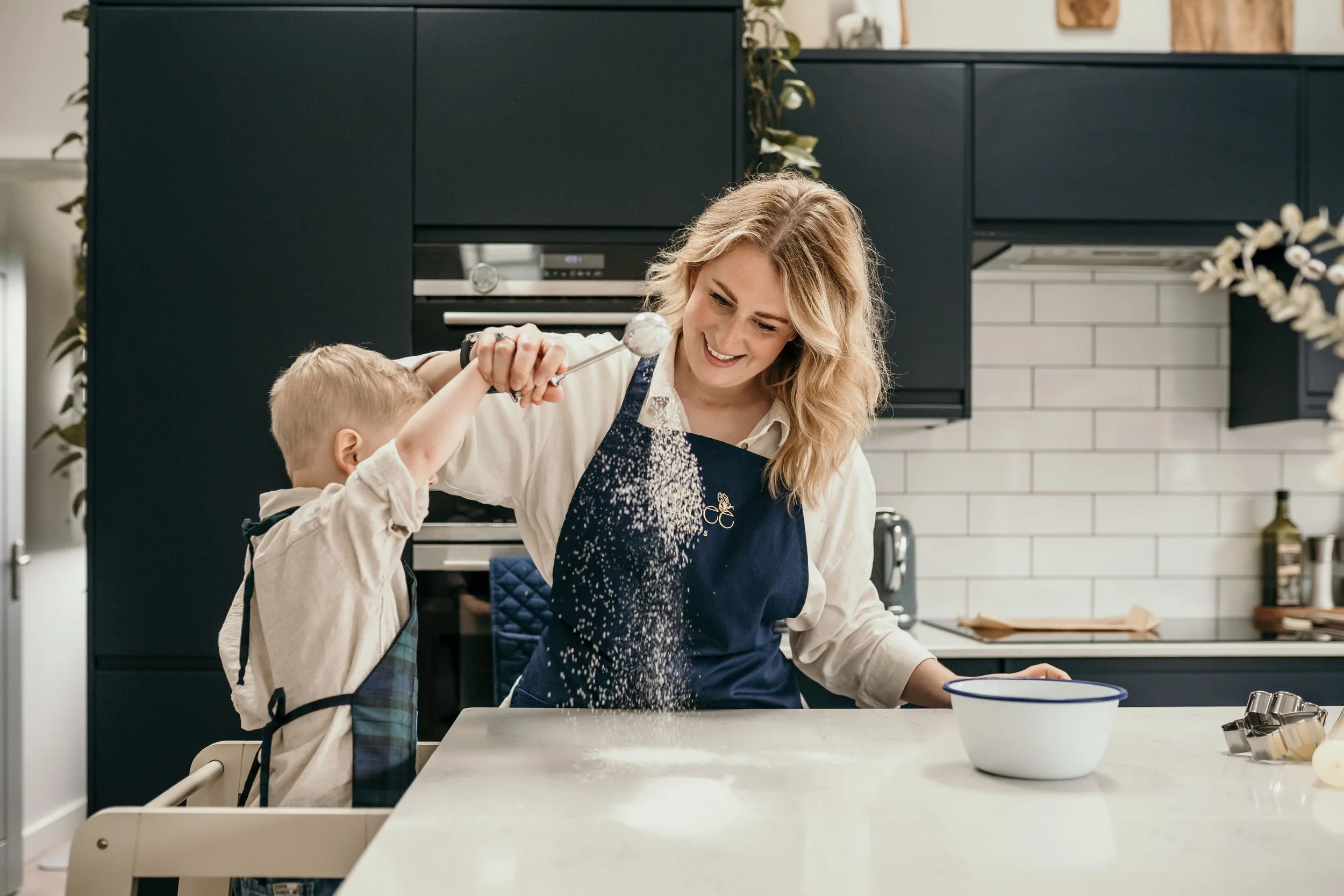 Mum and child baking together in the kitchen.