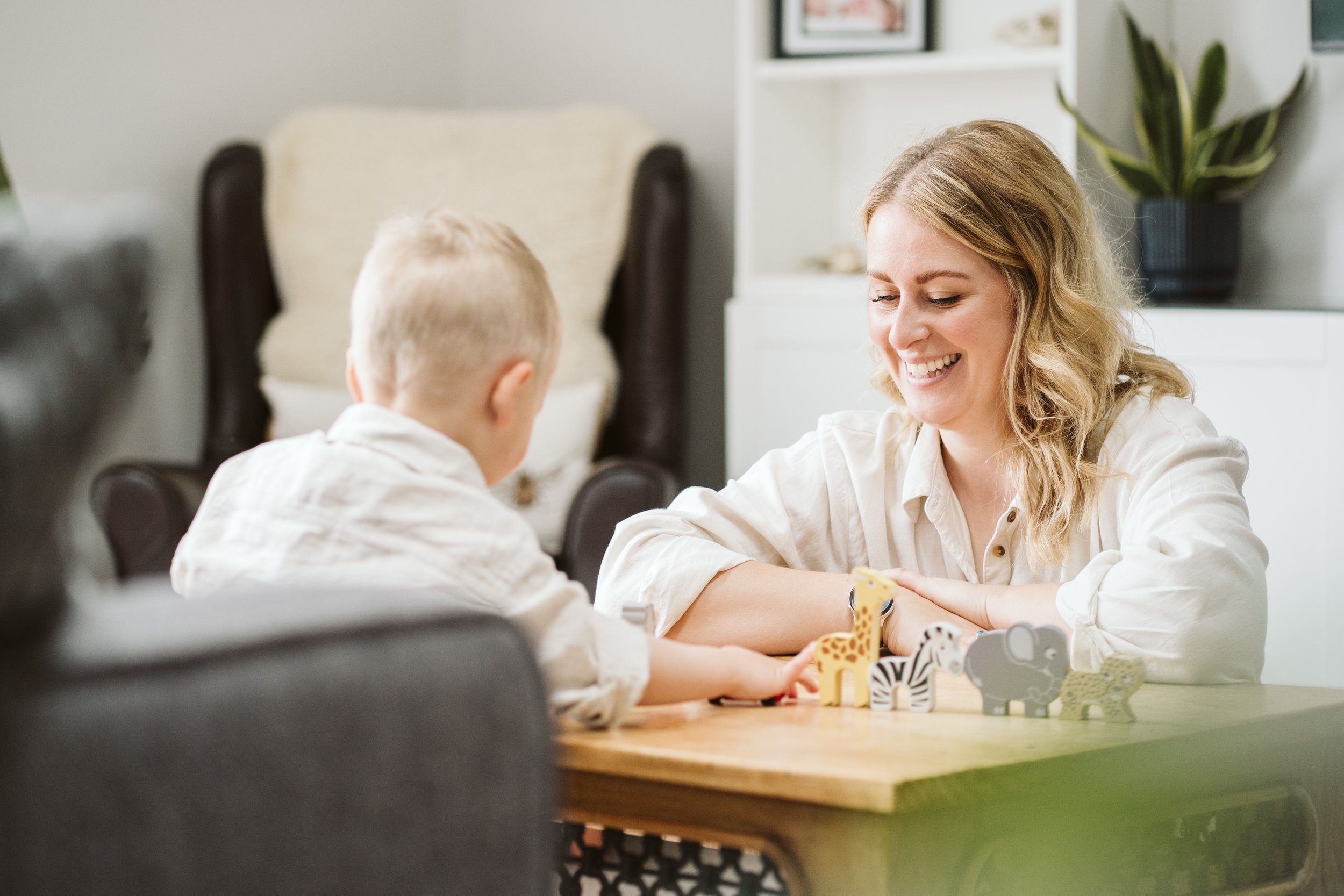 Mum and child sitting together at a table at home