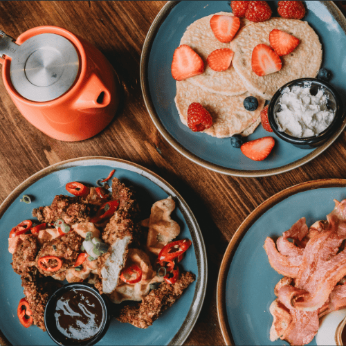A selection of dishes from The Barrelman's Brunch Menu including Fried Chicken Waffles, Eggs Benedict and Pancakes with Tea and Coffee