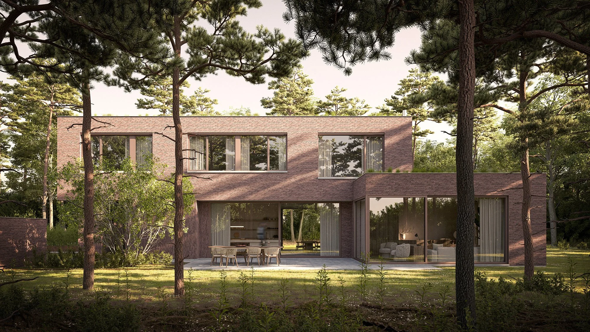 Modern two-story brick house surrounded by tall trees and greenery, with large glass windows and an outdoor patio.