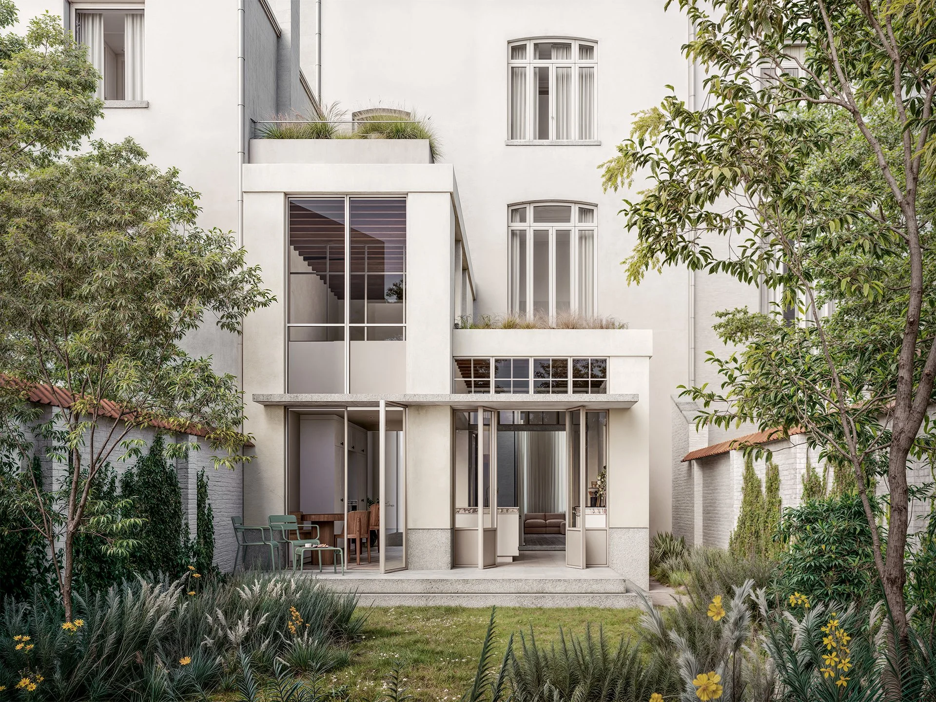 Modern multi-story house with large glass windows and patio, surrounded by greenery and trees.