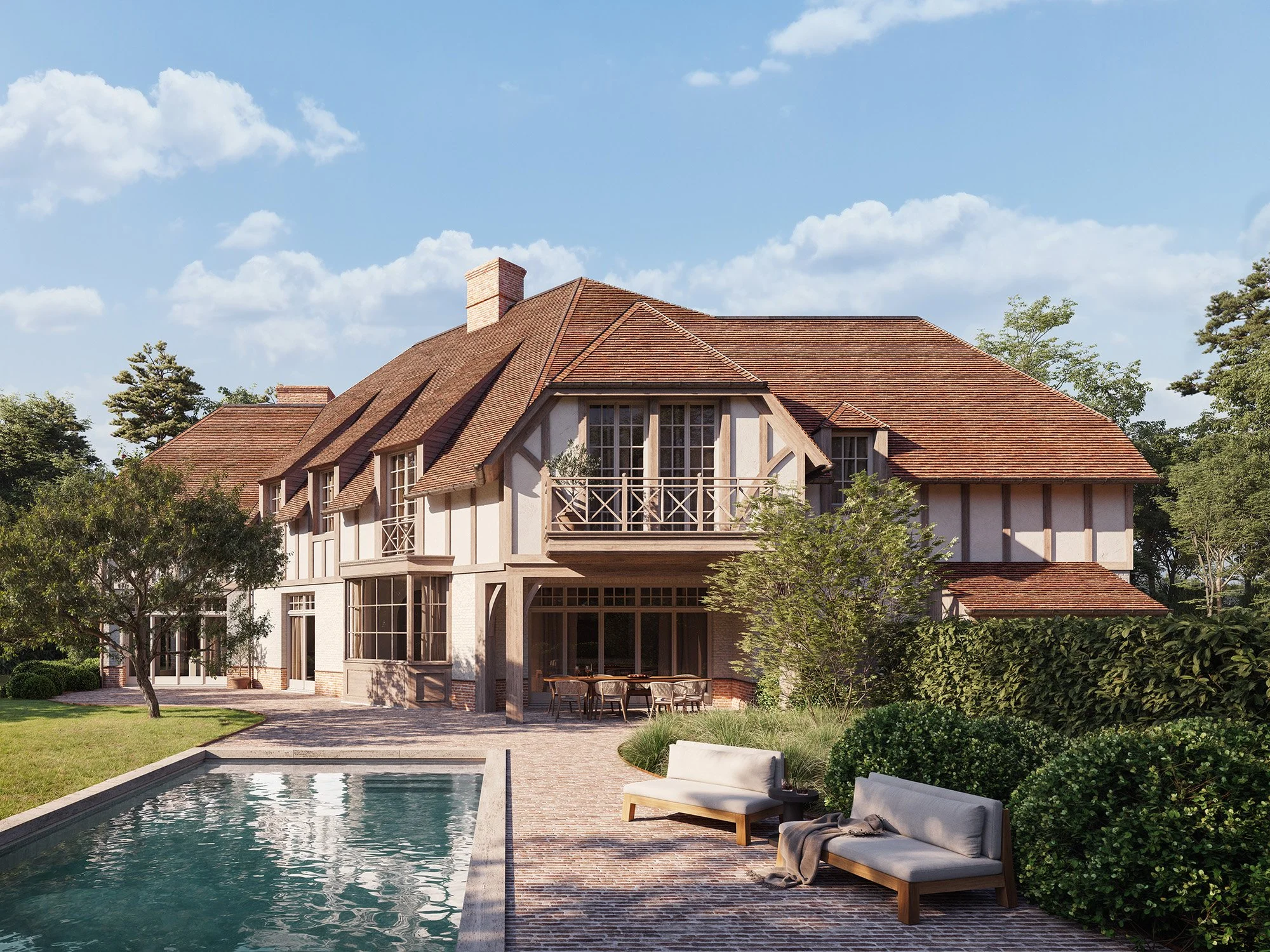 A large house with a red tiled roof, multiple windows, and a small balcony, surrounded by trees and a pool in the backyard with outdoor furniture.