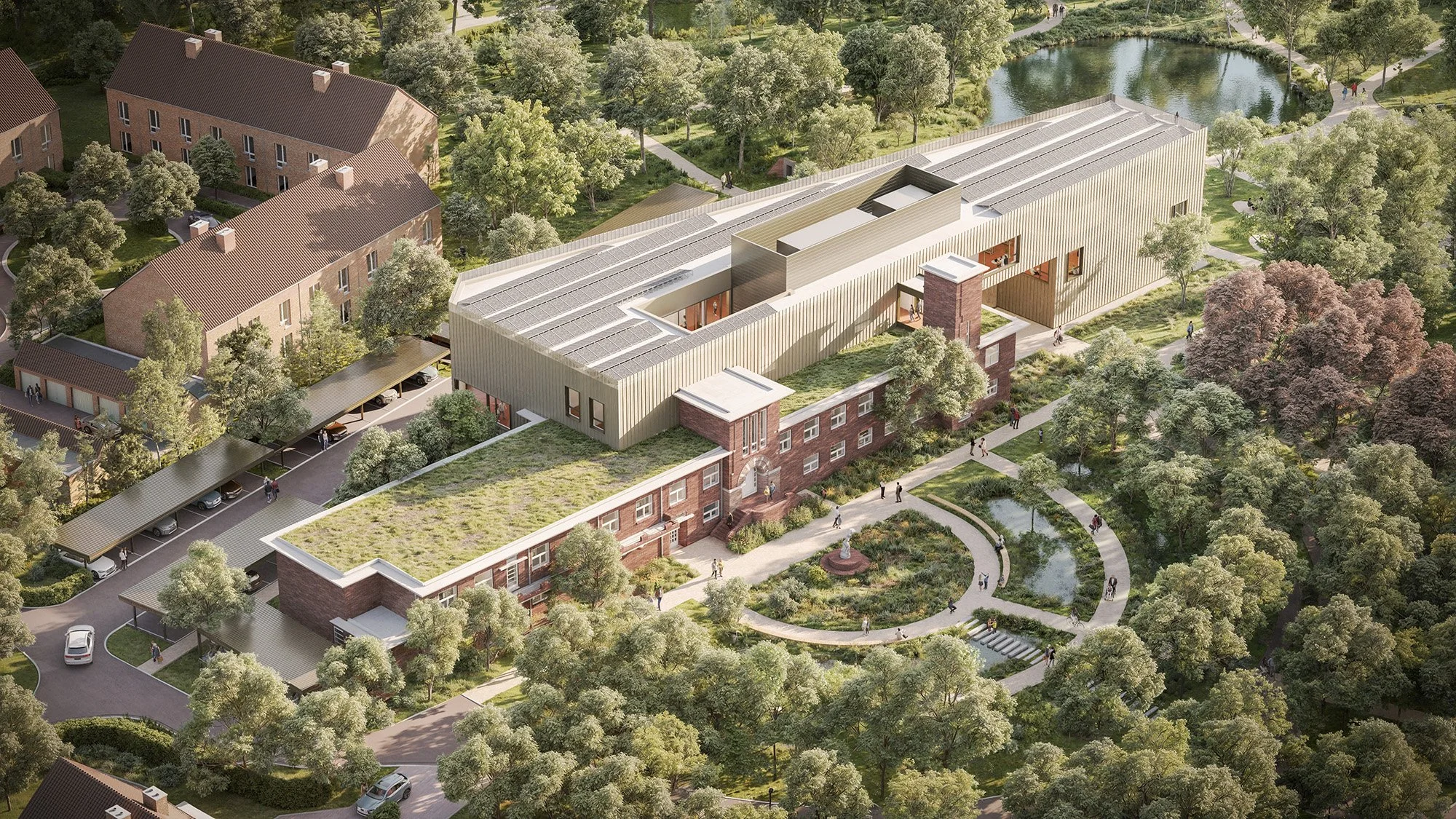 A modern multi-story building with a green roof and surrounding landscaped gardens, situated in a suburban area with trees, small lakes, walking paths, residential houses, and parking lots.