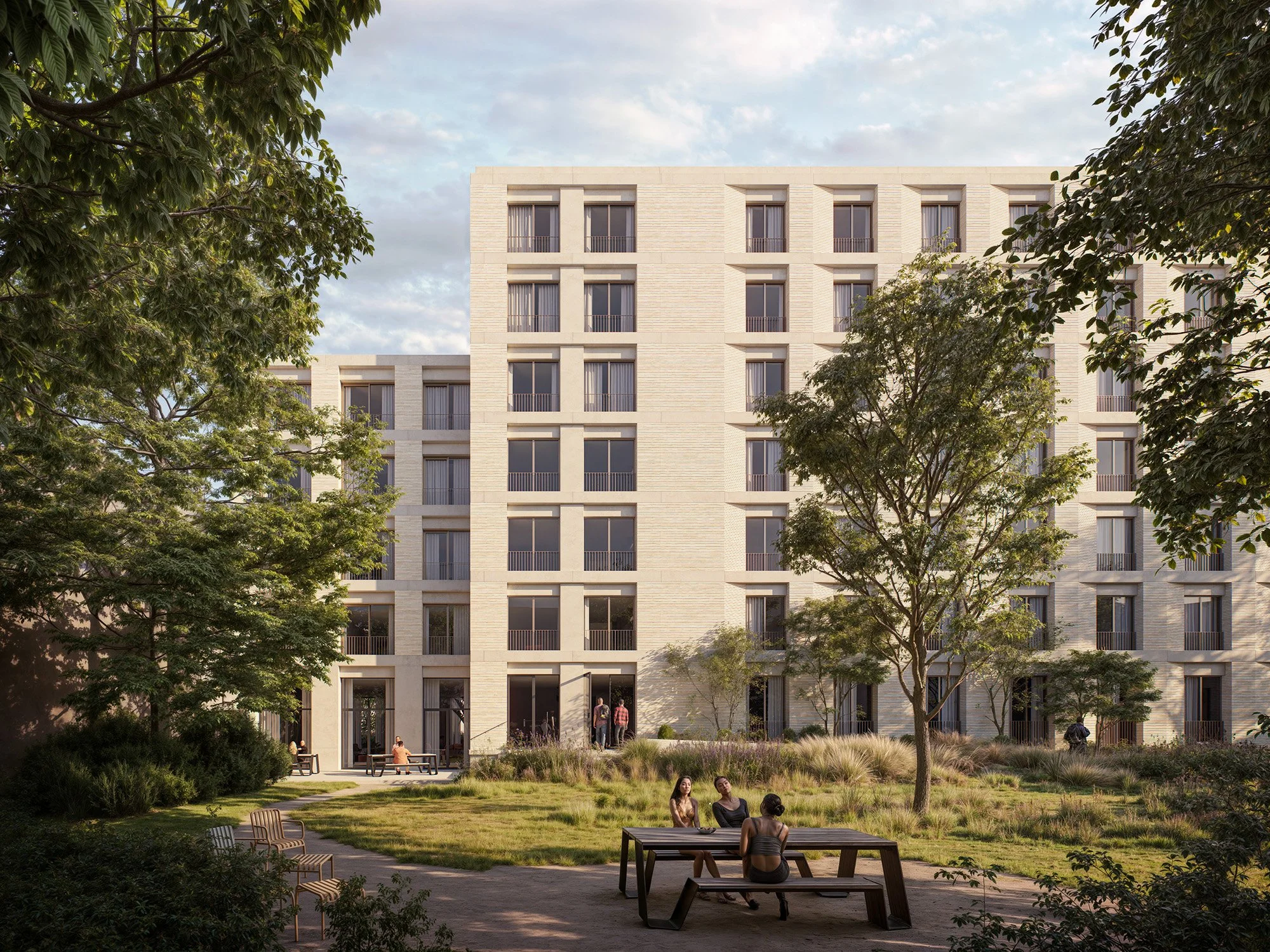 A modern multi-story apartment building with large windows and balconies, surrounded by trees and a landscaped courtyard with walking paths and benches, during daytime.
