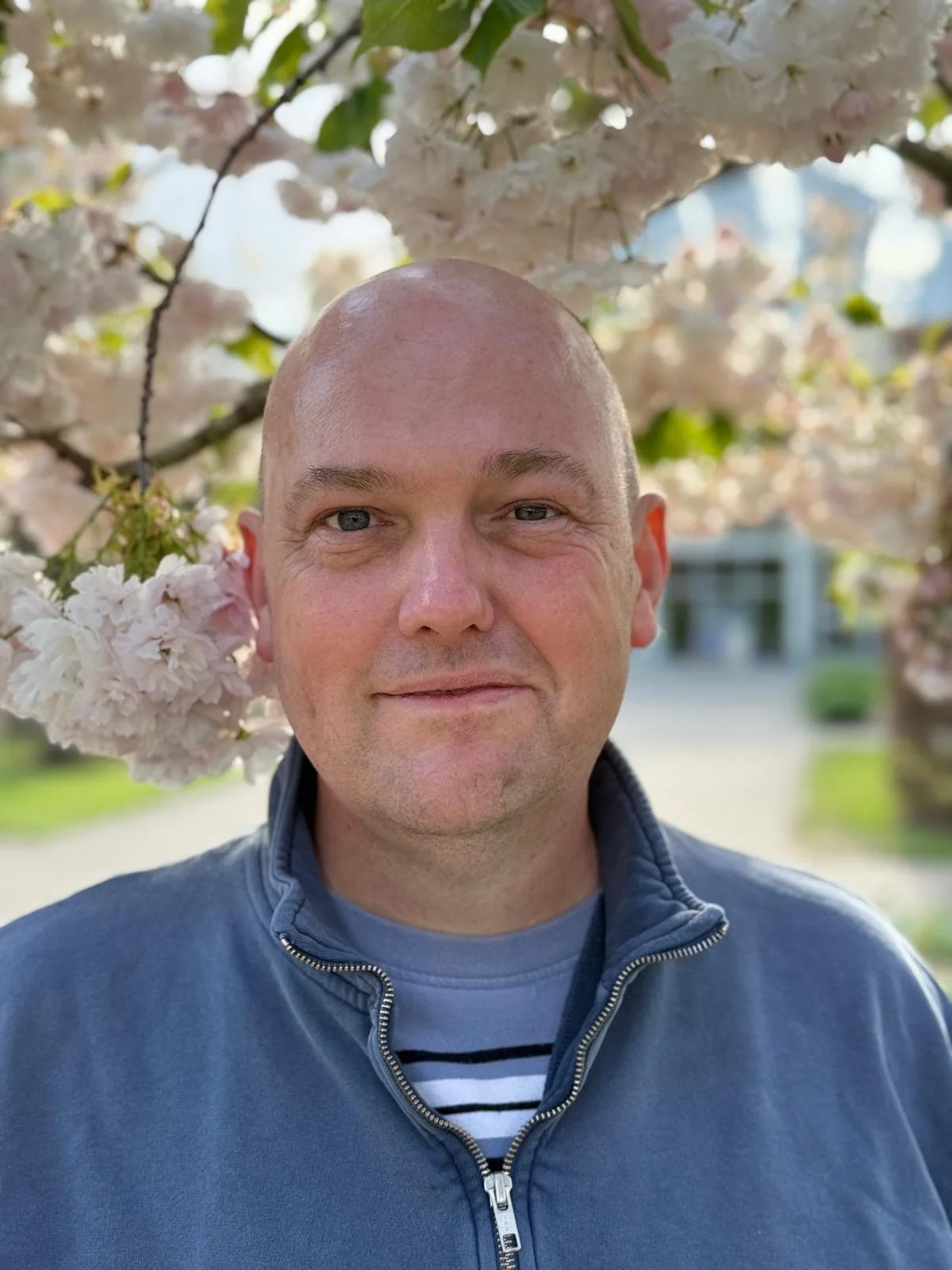 Steve Andrews, senior designer at Vivid Gardens, in a garden under spring blossom