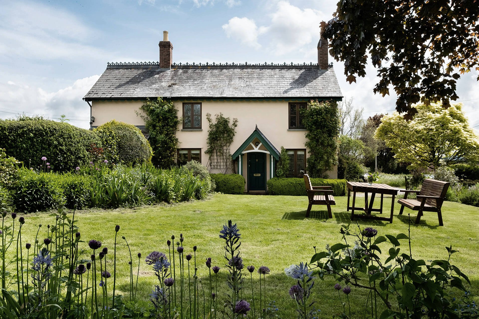 Well-kept front garden with seating, ideal for initial design discussion